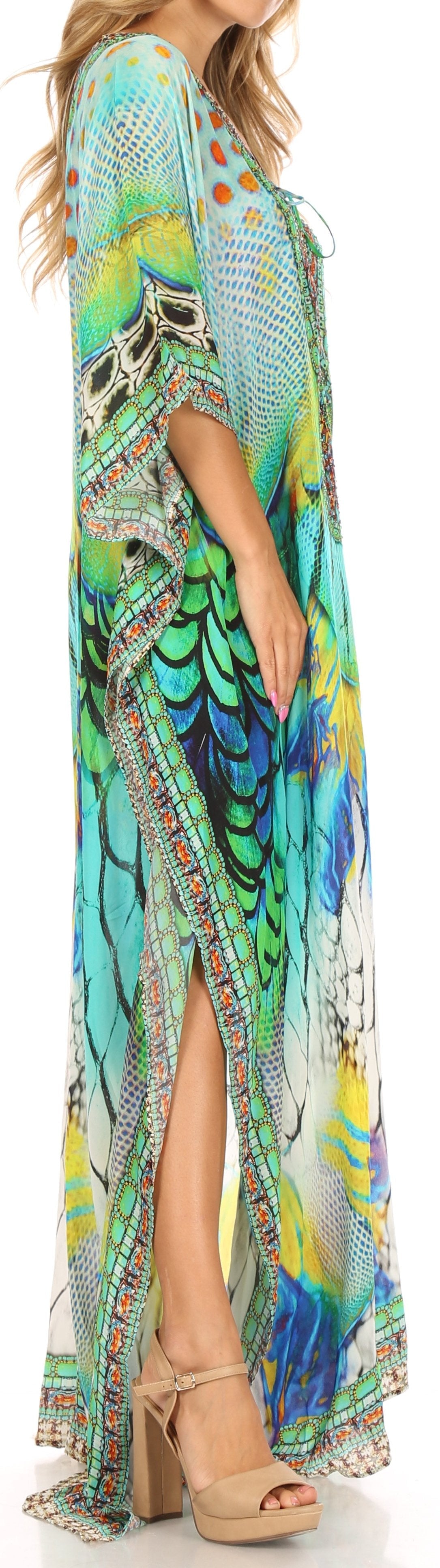 Woman wearing a colorful patterned dress with a high slit, standing against a neutral background.