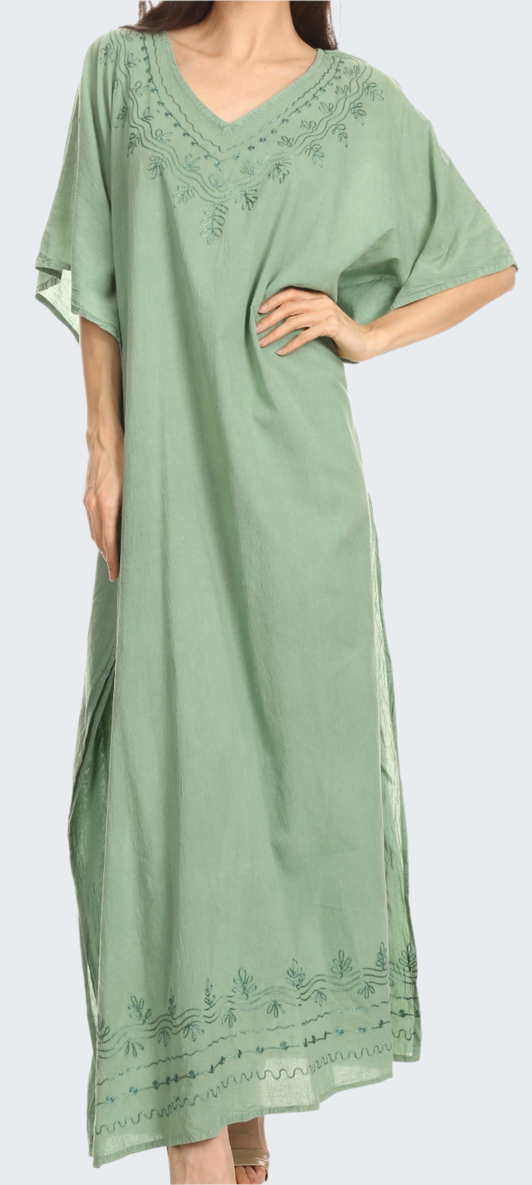 Woman wearing a green dress with embroidery on a white background