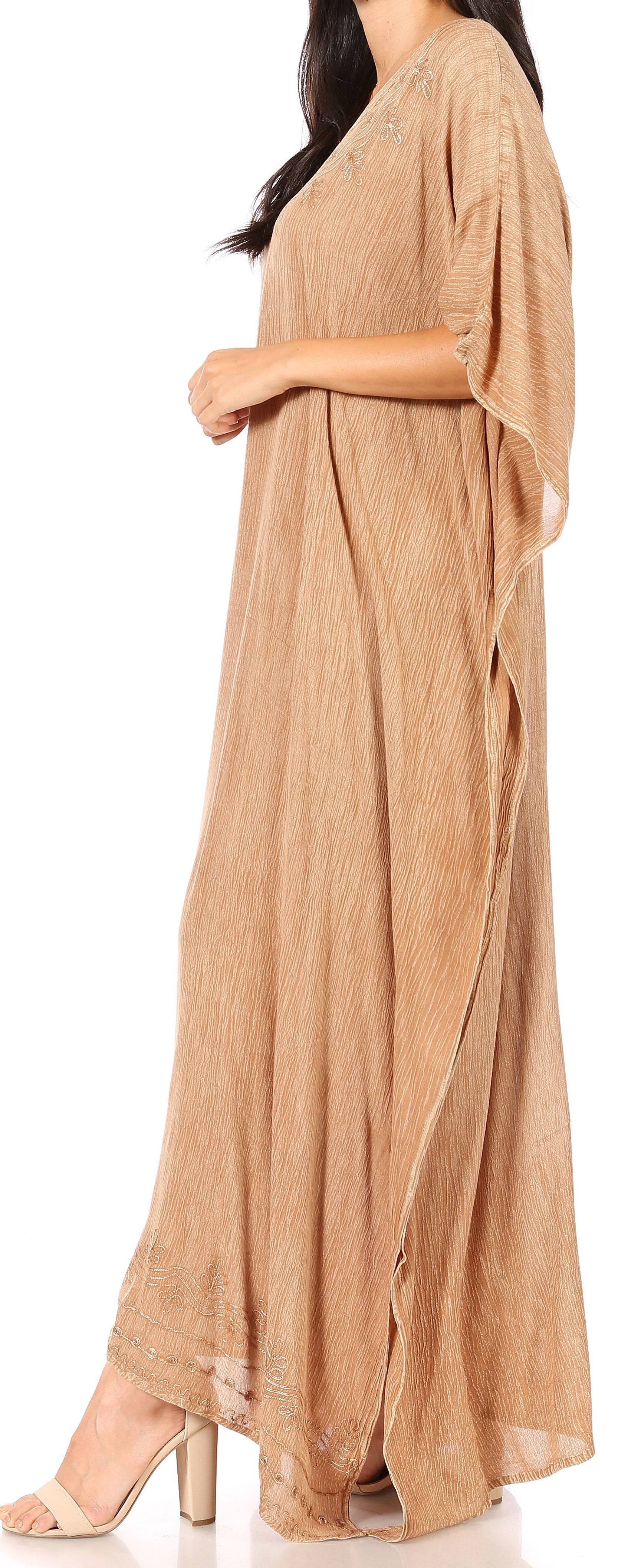 Woman wearing a beige flowing dress on a white background