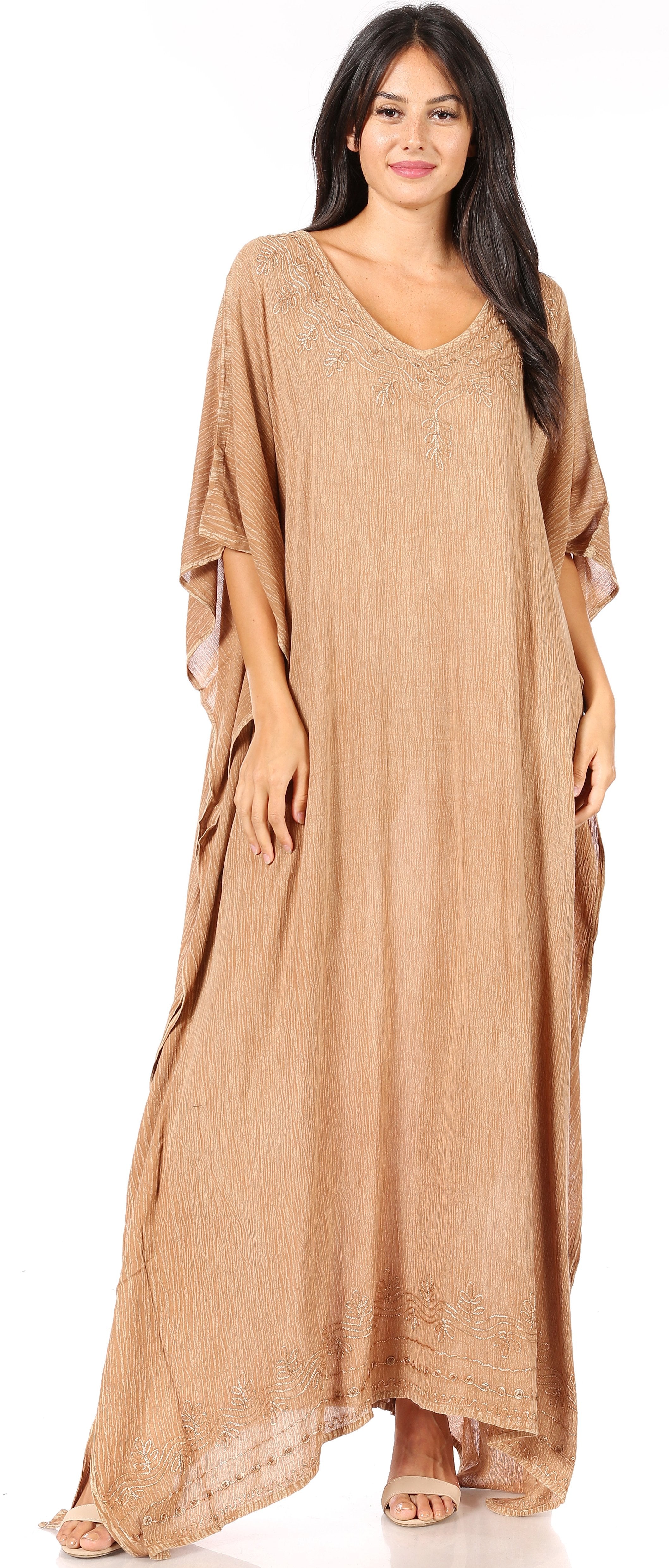 Woman wearing a long beige dress on a white background