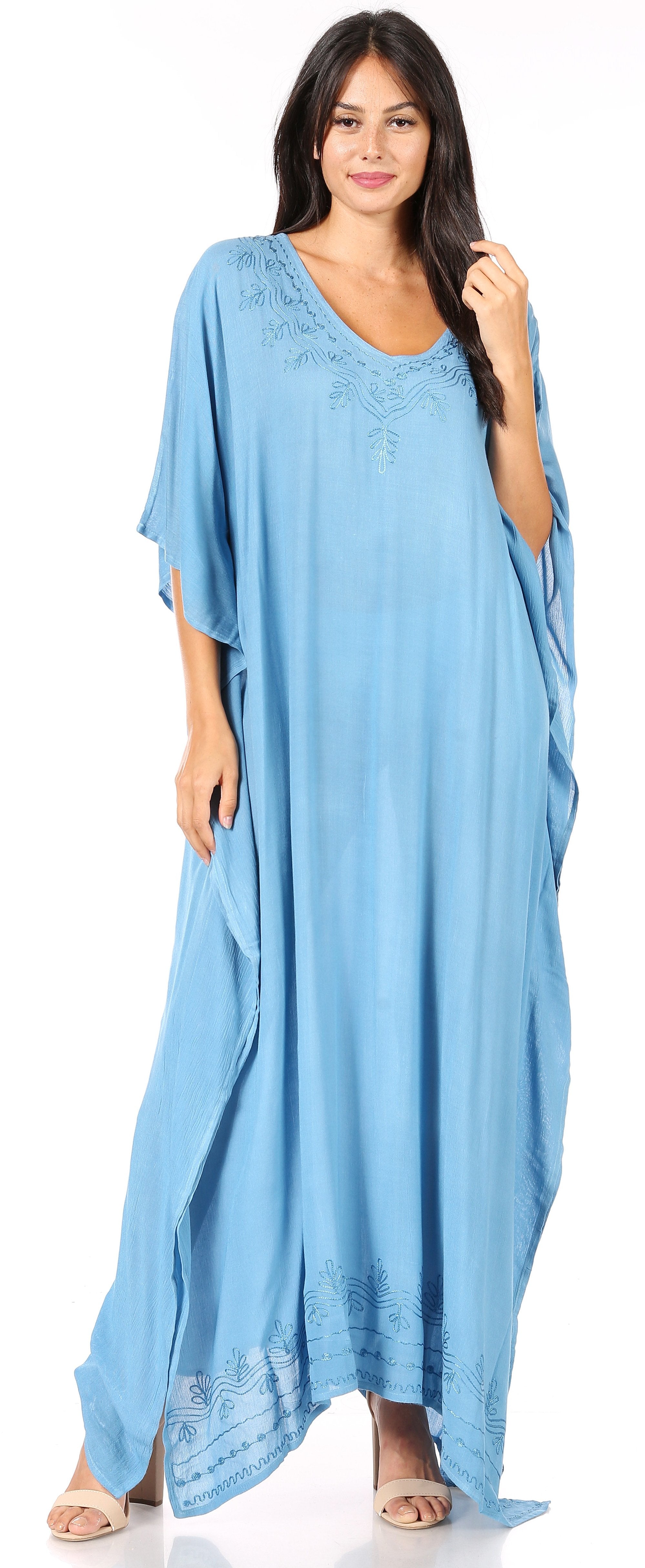 Woman wearing a light blue maxi dress with a white background