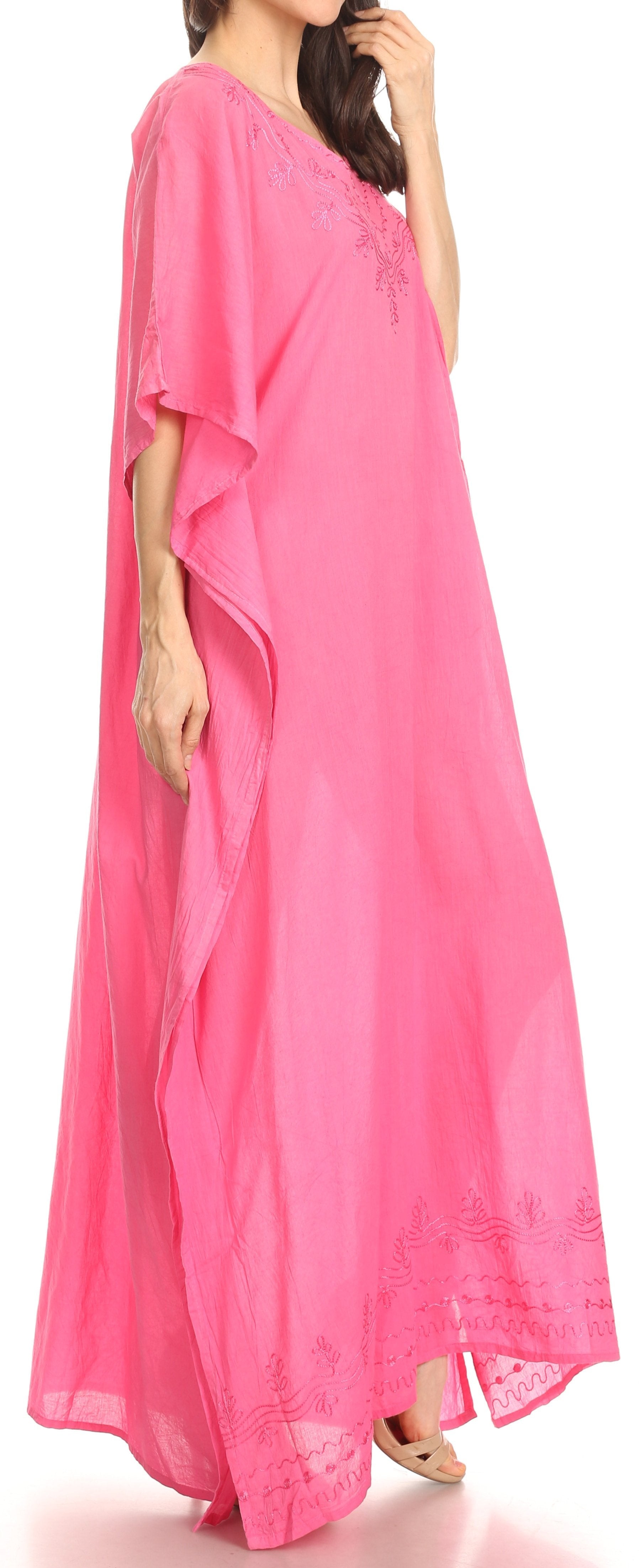 Woman wearing a pink flowing dress on a white background