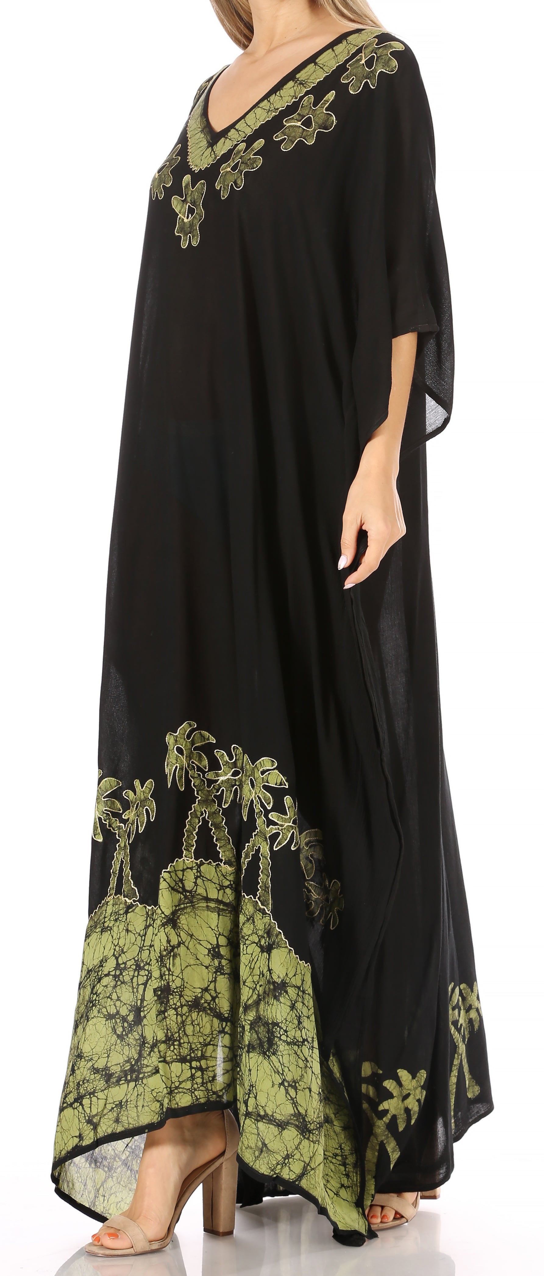 Black caftan with green floral embroidery on a white background