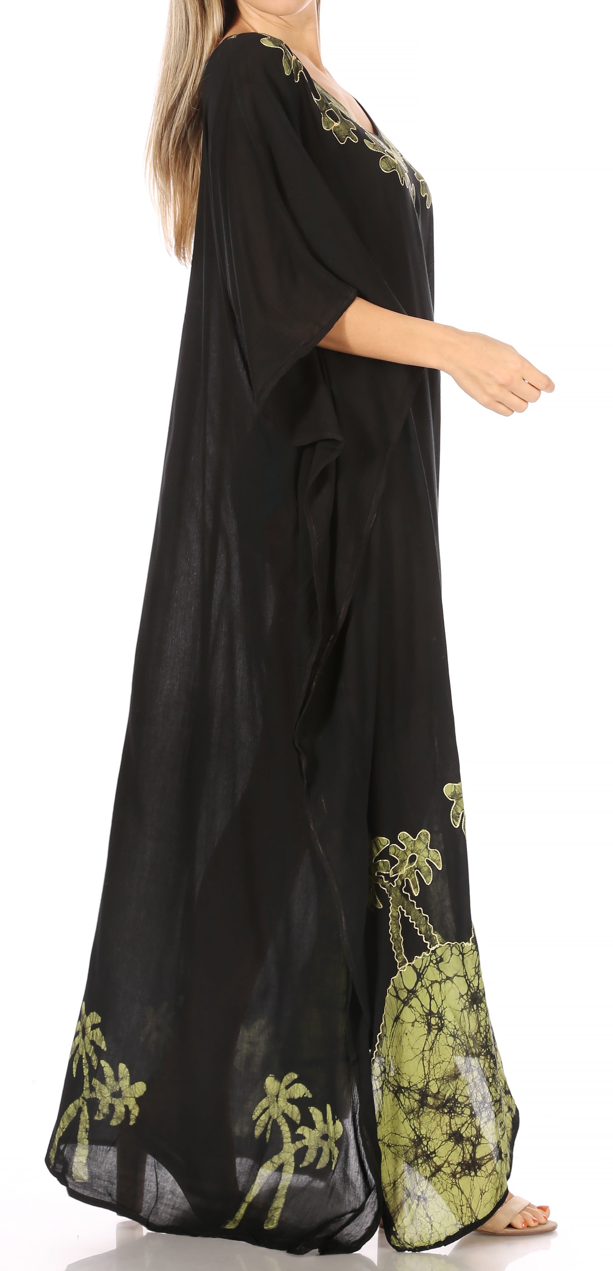 Black dress with green floral patterns on a white background