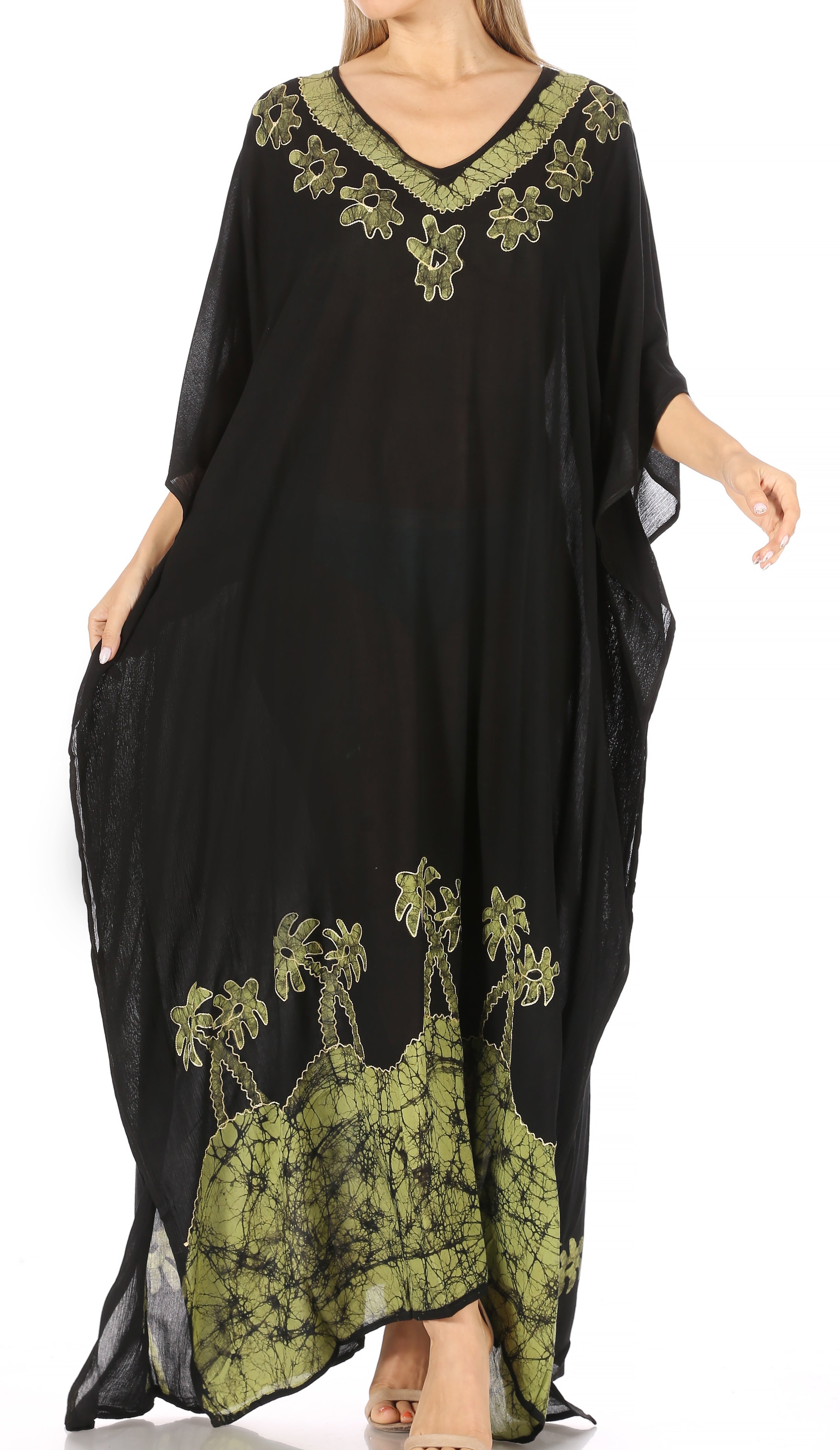 Black dress with green floral embroidery on a white background