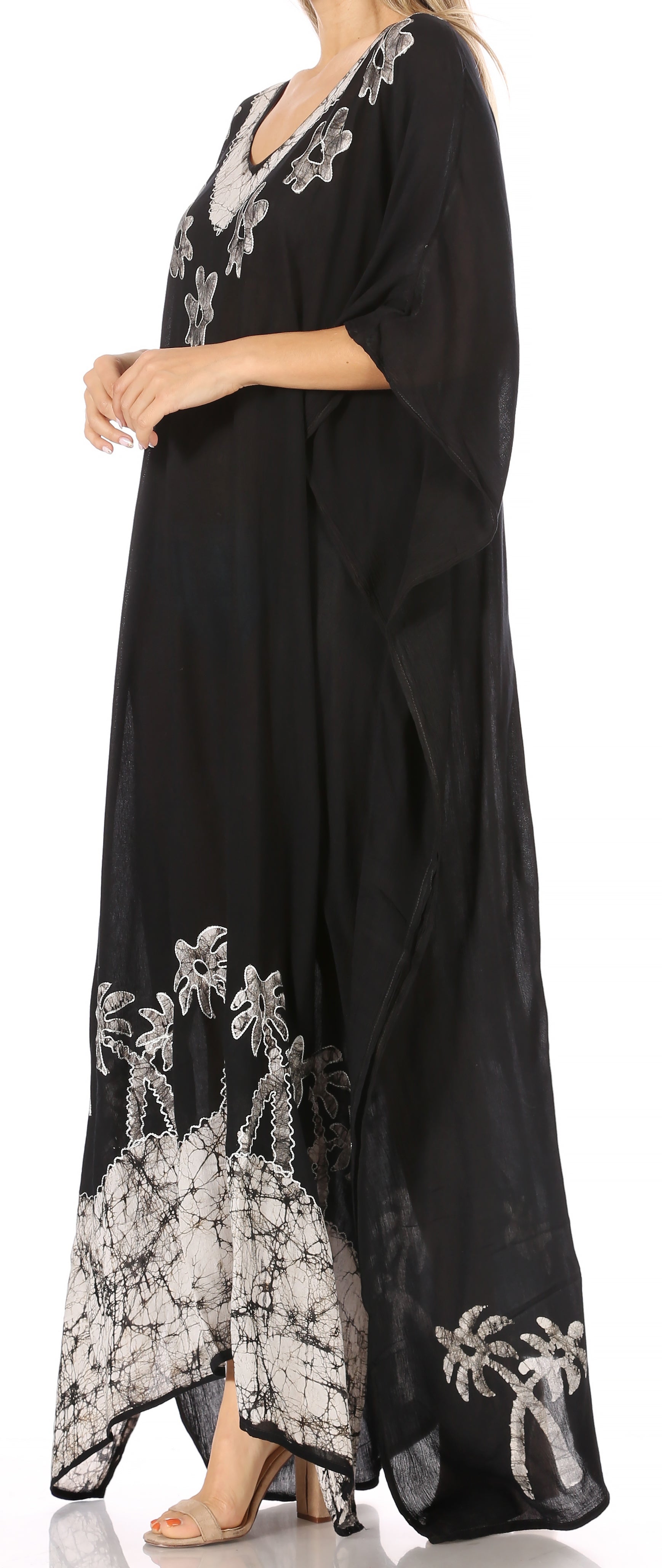 Black dress with white floral embroidery on a white background
