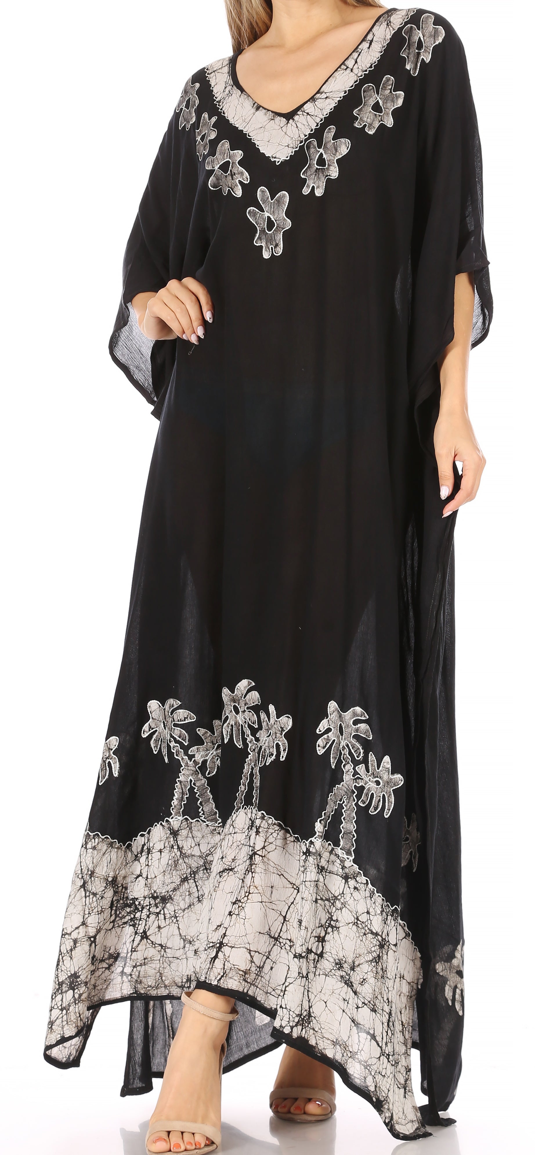 Black dress with white floral embroidery on a white background