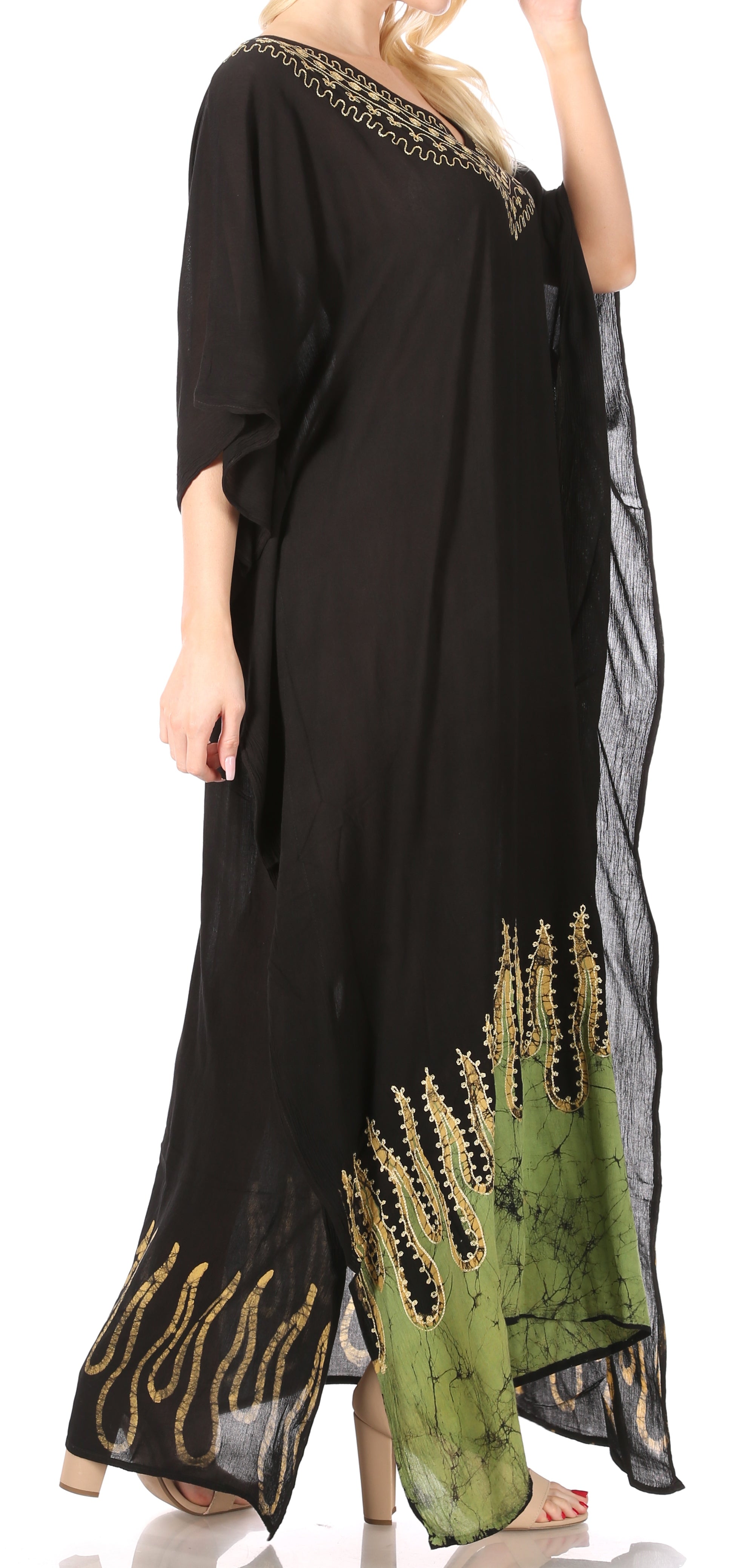 Black dress with green and gold embroidery on a white background