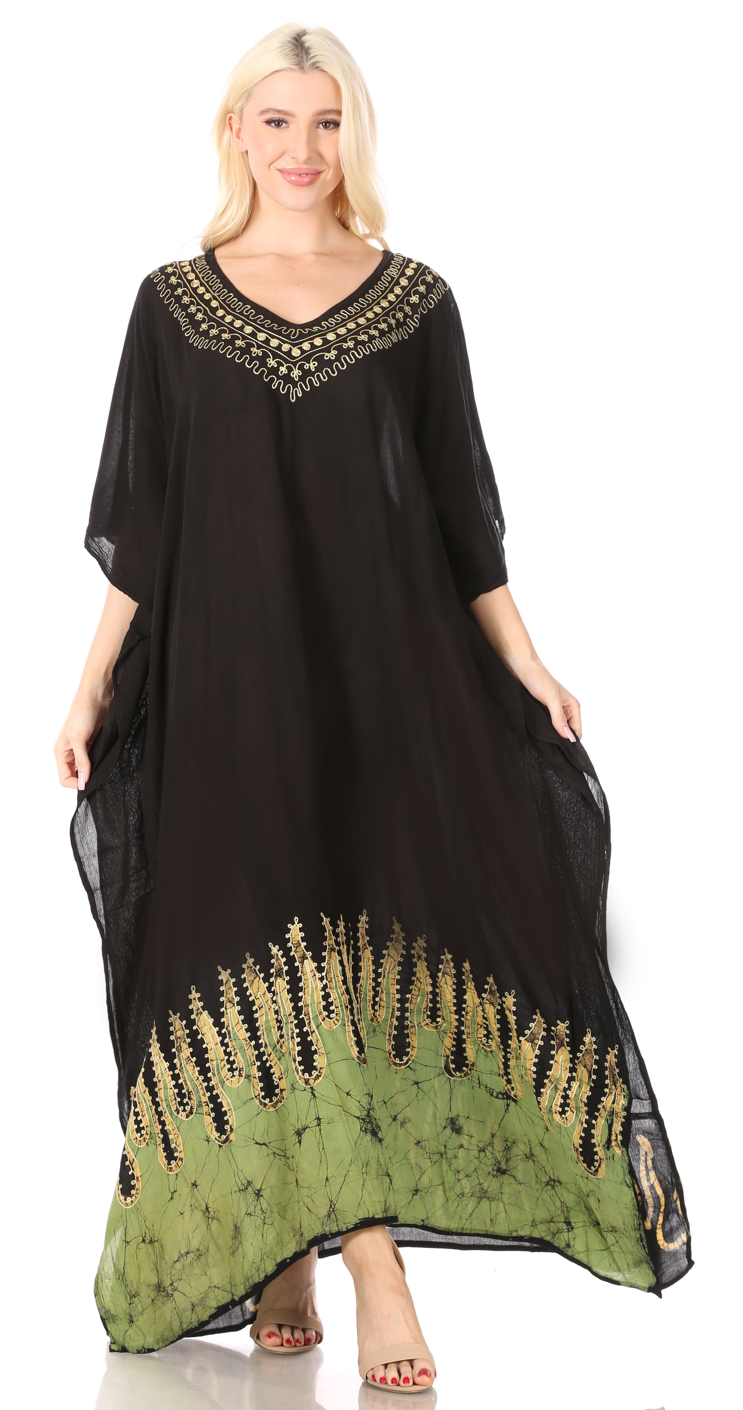 Woman wearing a black and green dress with embroidery on a white background