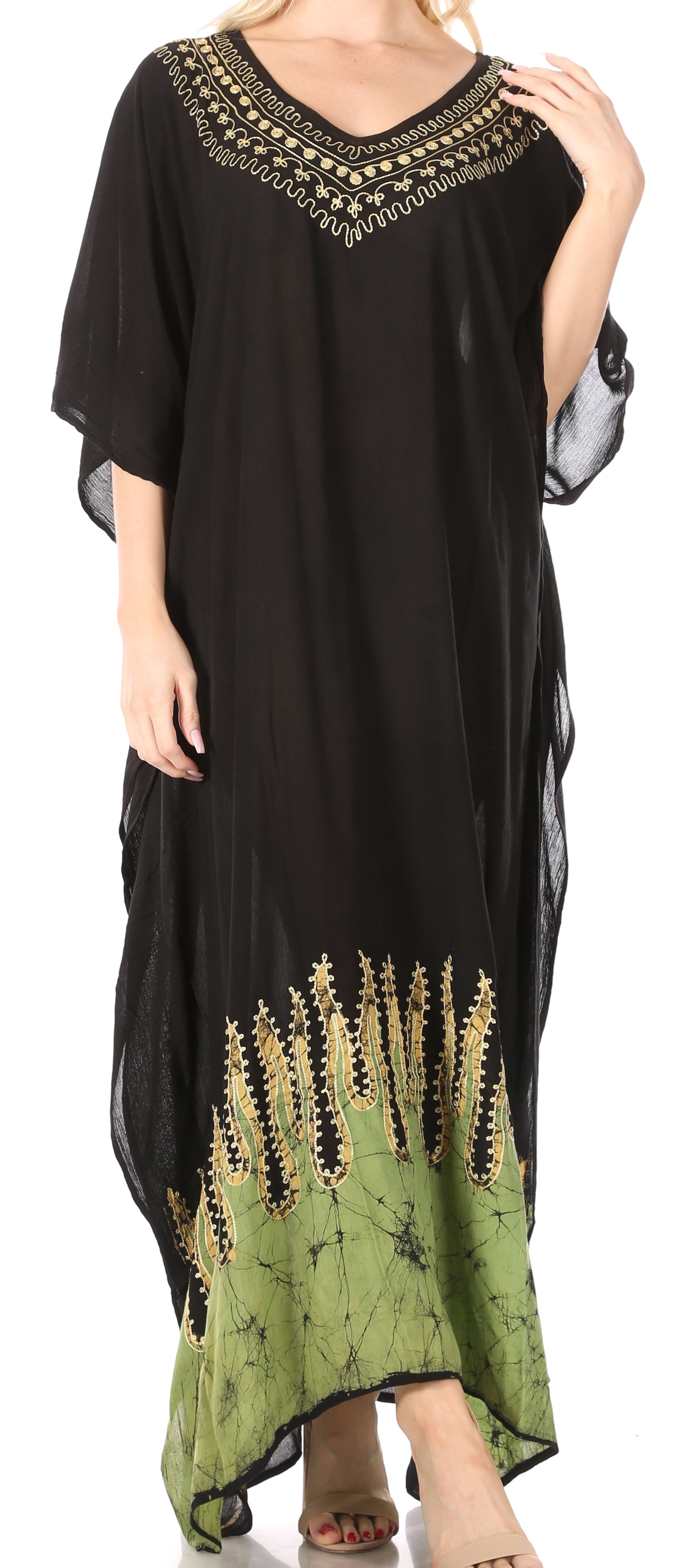 Black and green dress with embroidery, worn by a person.