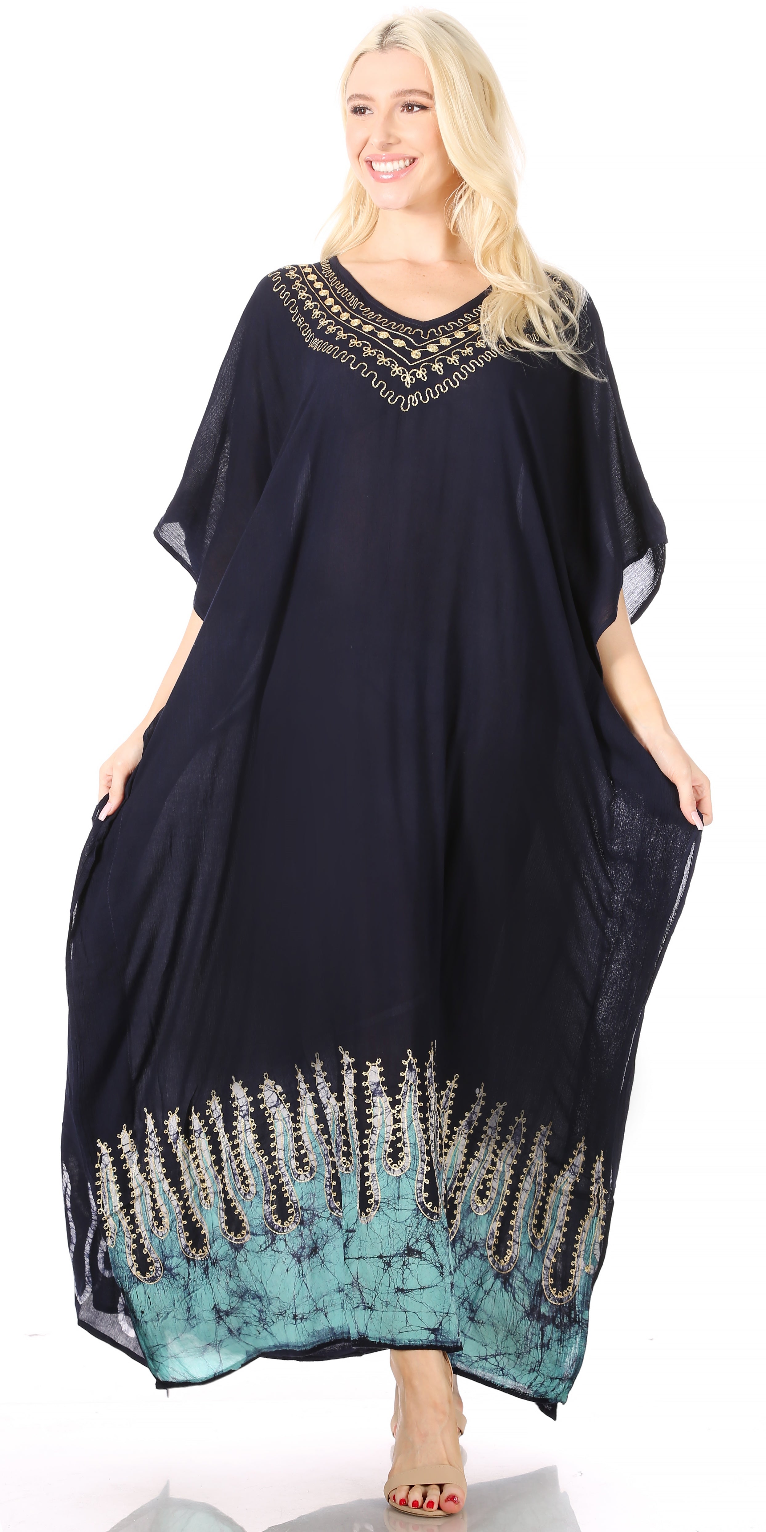 Woman wearing a black and blue dress with decorative patterns on a white background