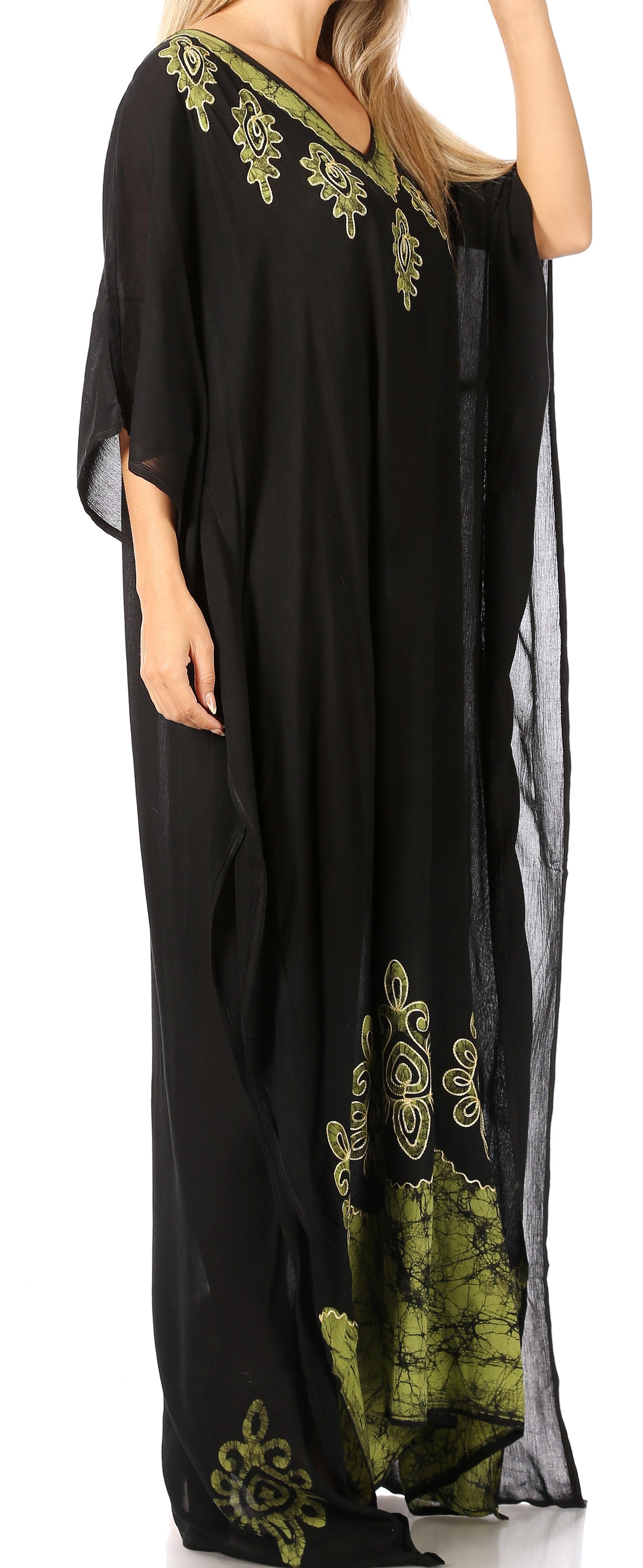 Black dress with green floral embroidery on a white background