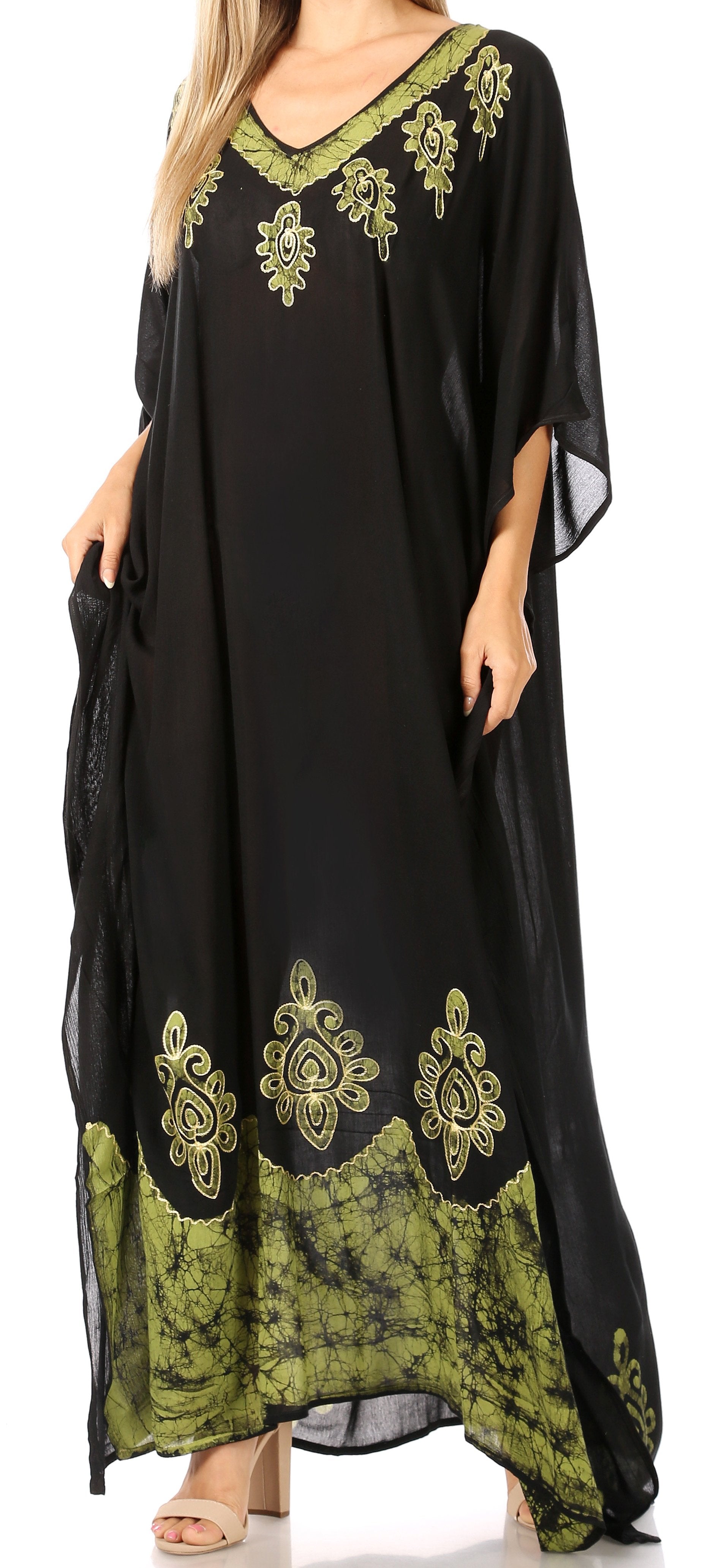 Black and green embroidered dress with a model wearing it.