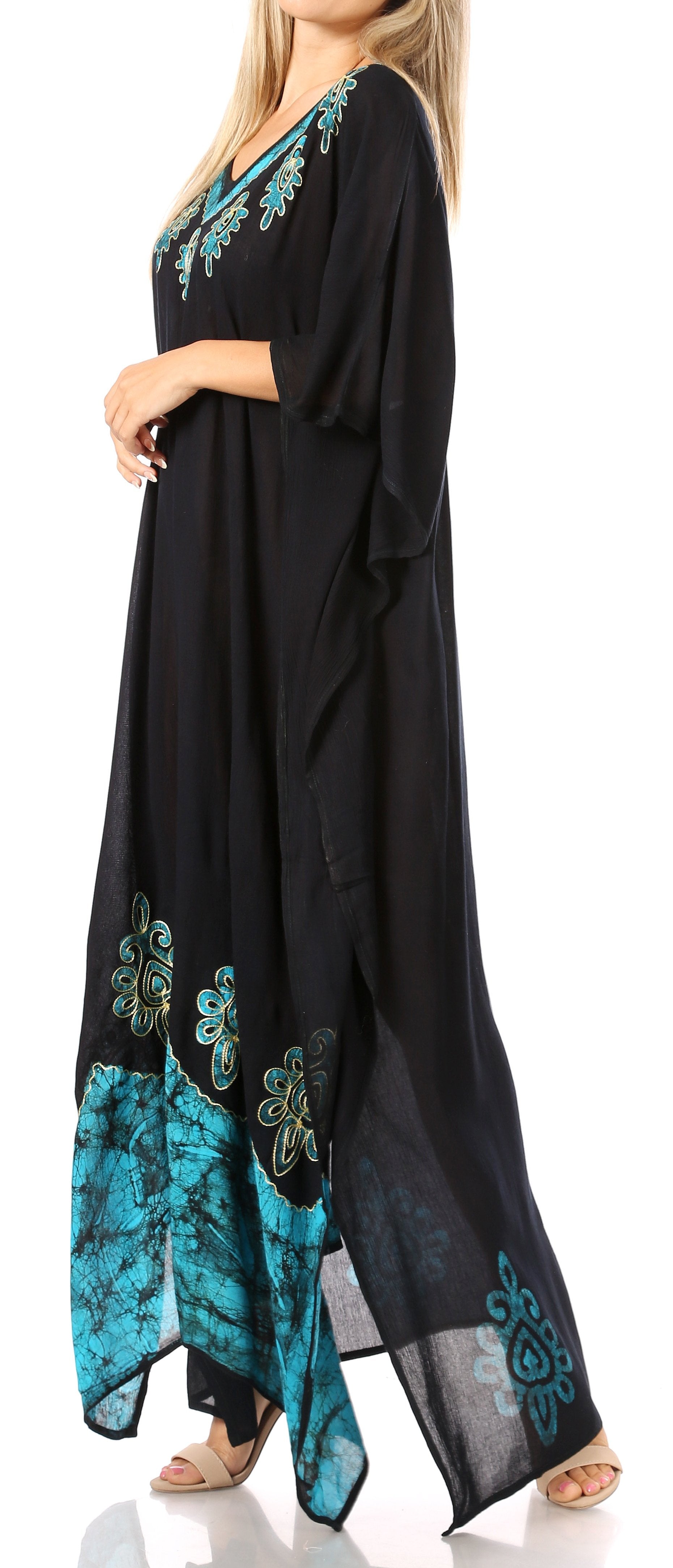 Black dress with teal floral embroidery worn by a model on a white background