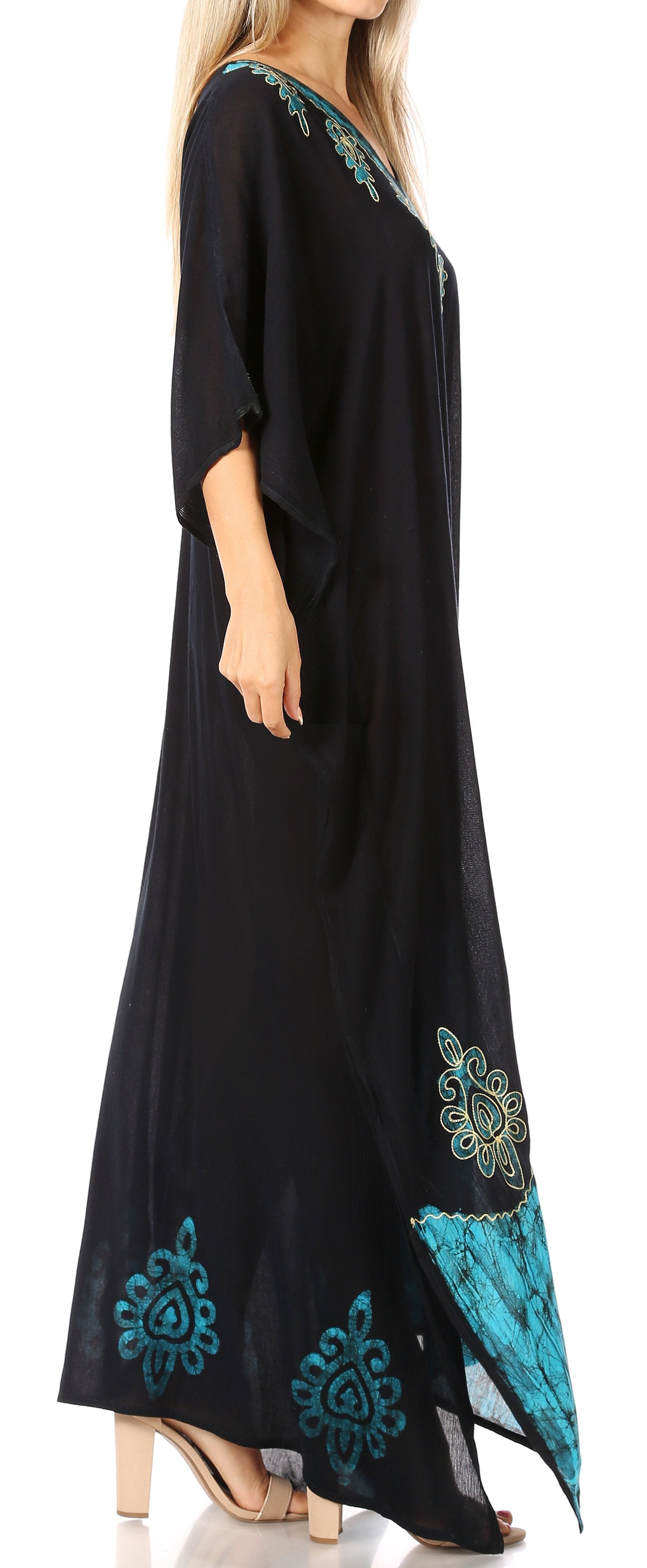 Black dress with teal embroidery on a white background