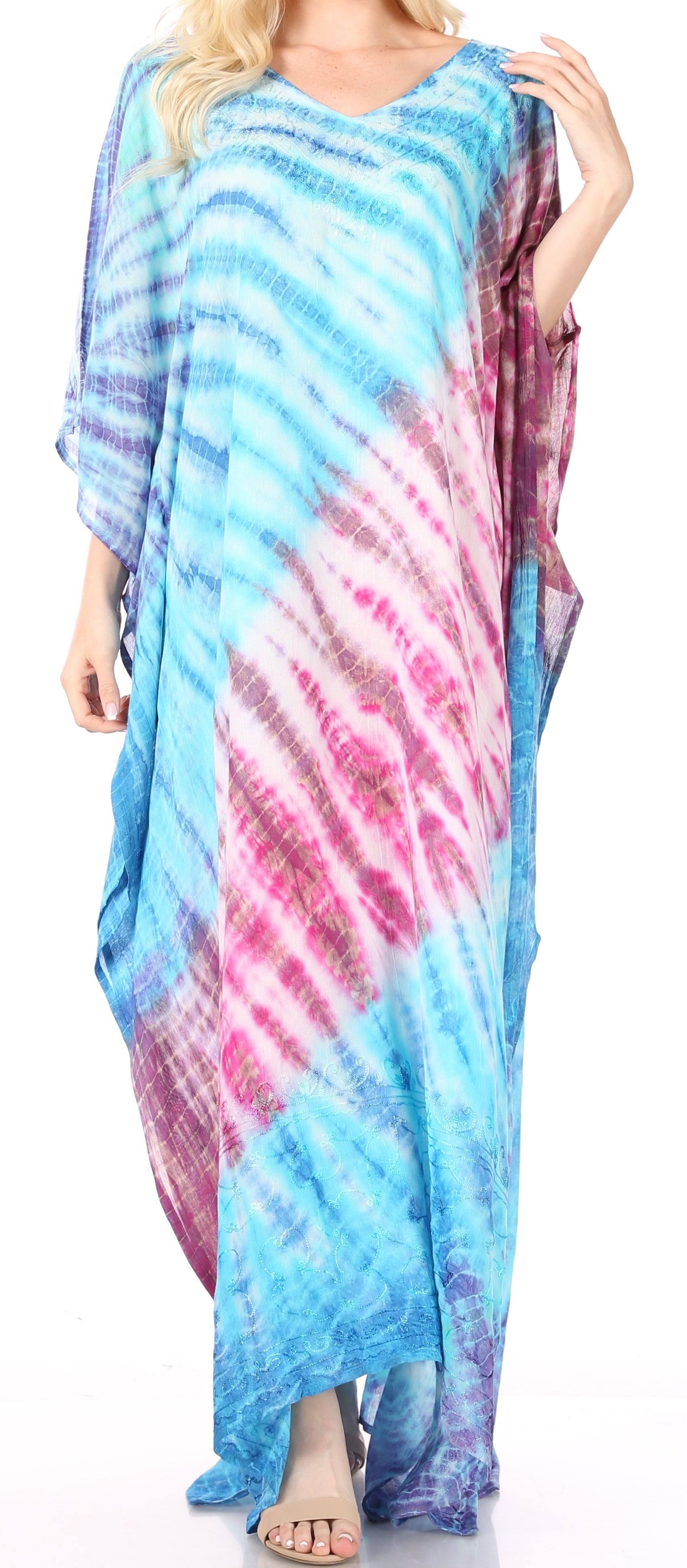 Woman wearing a colorful tie-dye dress with a gradient of blue, pink, and purple.