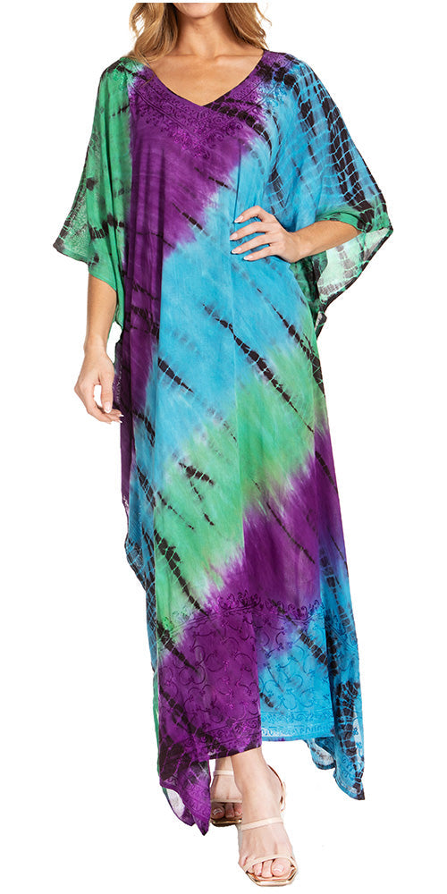 Woman wearing a tie-dye dress with green, blue, and purple colors on a white background.