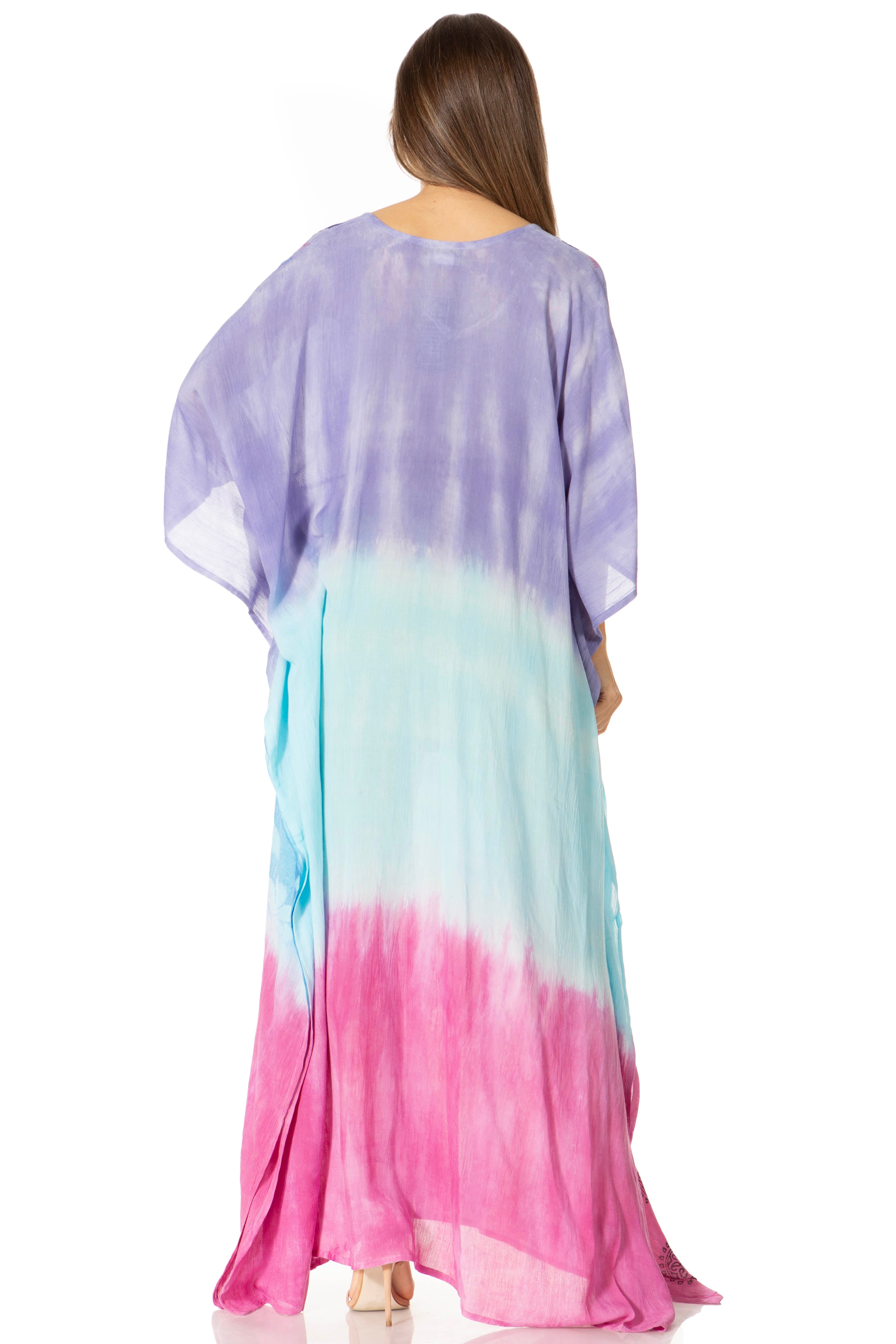 Woman wearing a colorful tie-dye dress with a gradient from purple to pink.