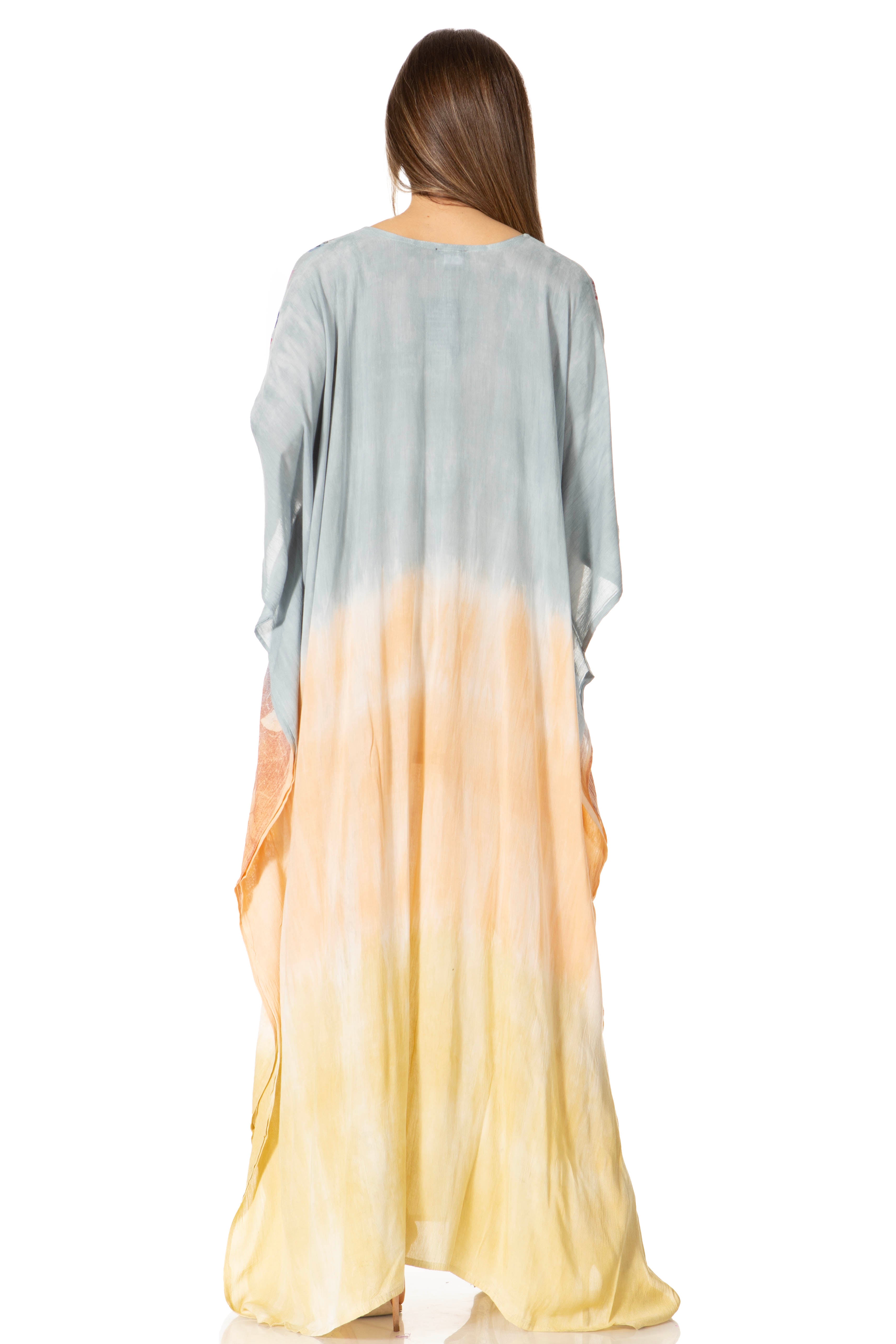 Woman wearing a long, gradient dress with gray at the top and yellow at the bottom on a white background.