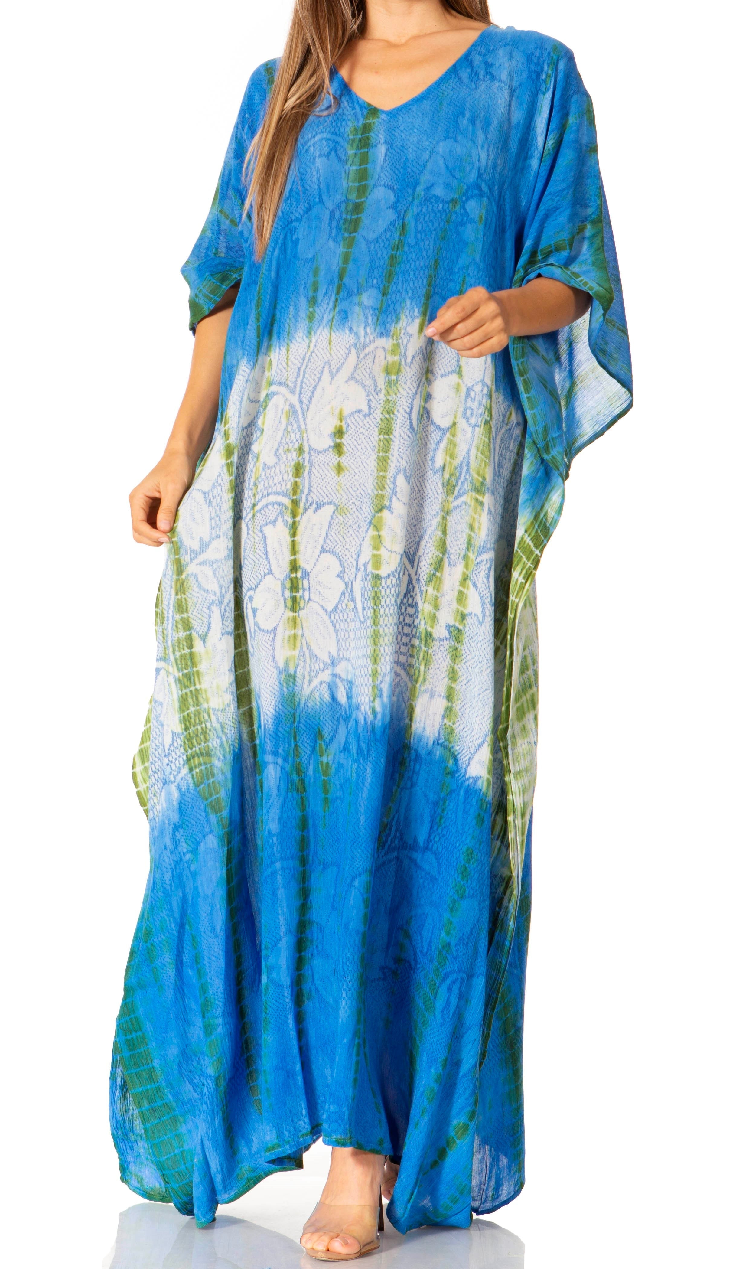 Woman wearing a blue tie-dye dress with floral patterns on a white background