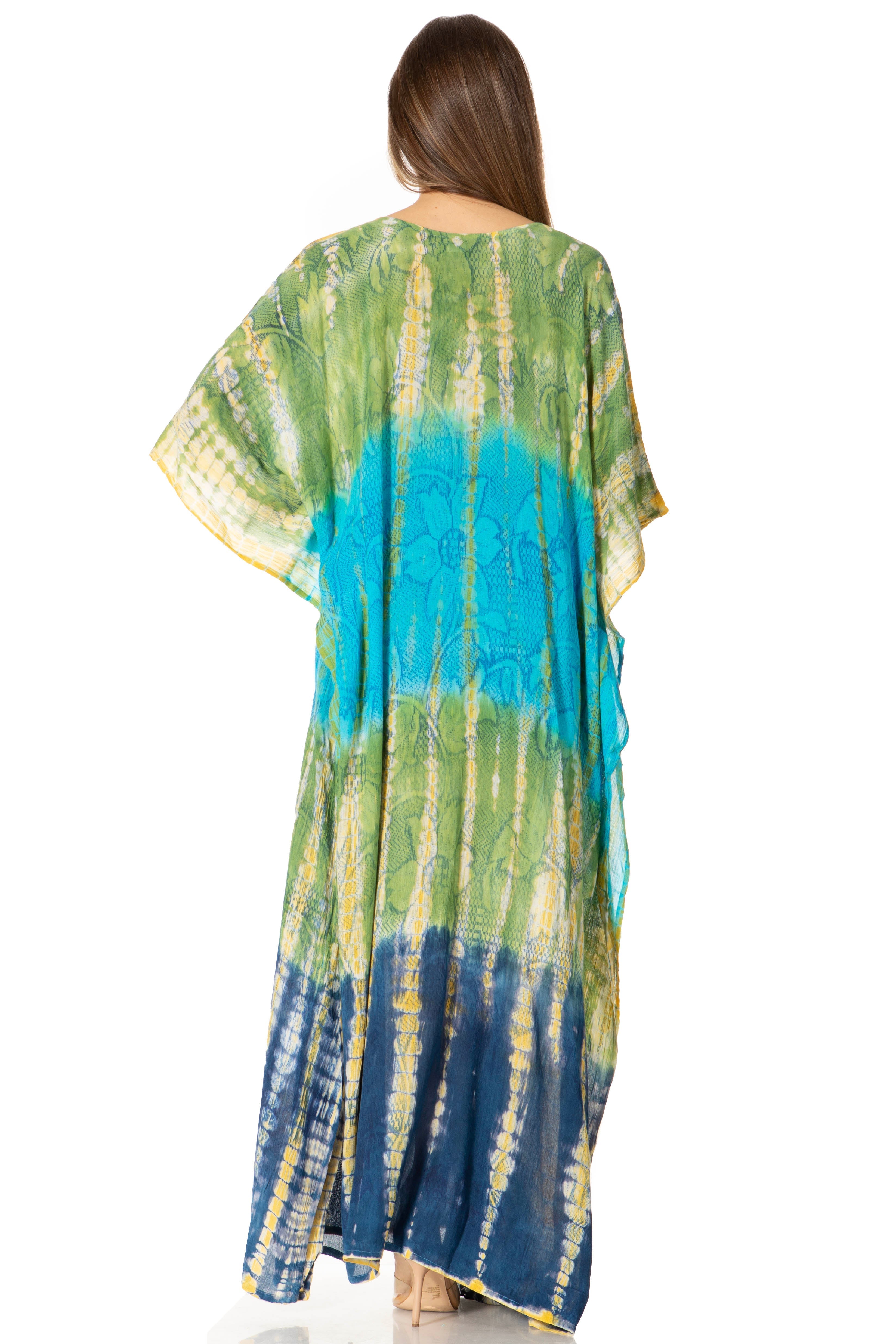 Woman wearing a tie-dye caftan with green, blue, and yellow colors on a white background