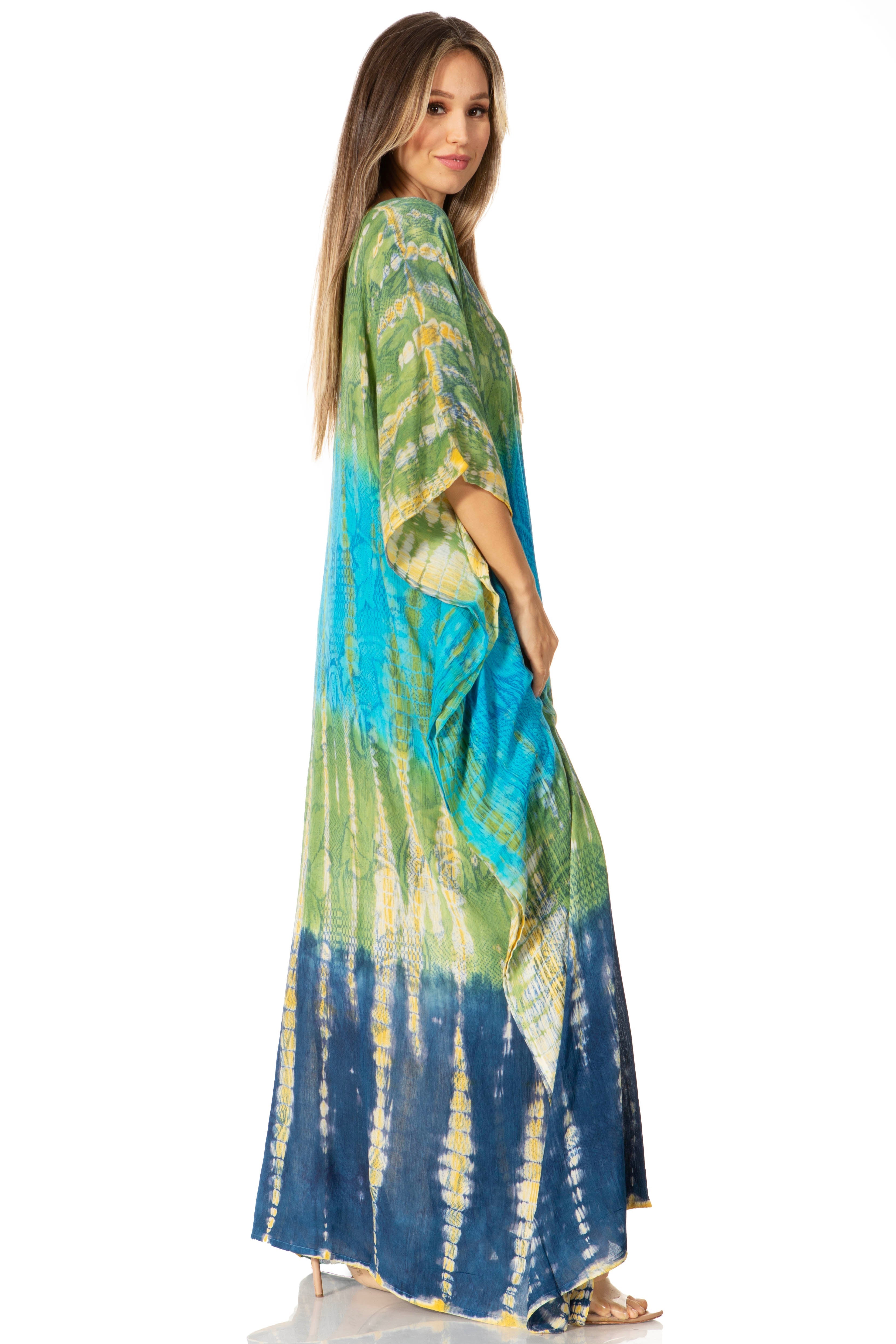 Woman wearing a tie-dye dress with green, blue, and yellow gradient on a white background