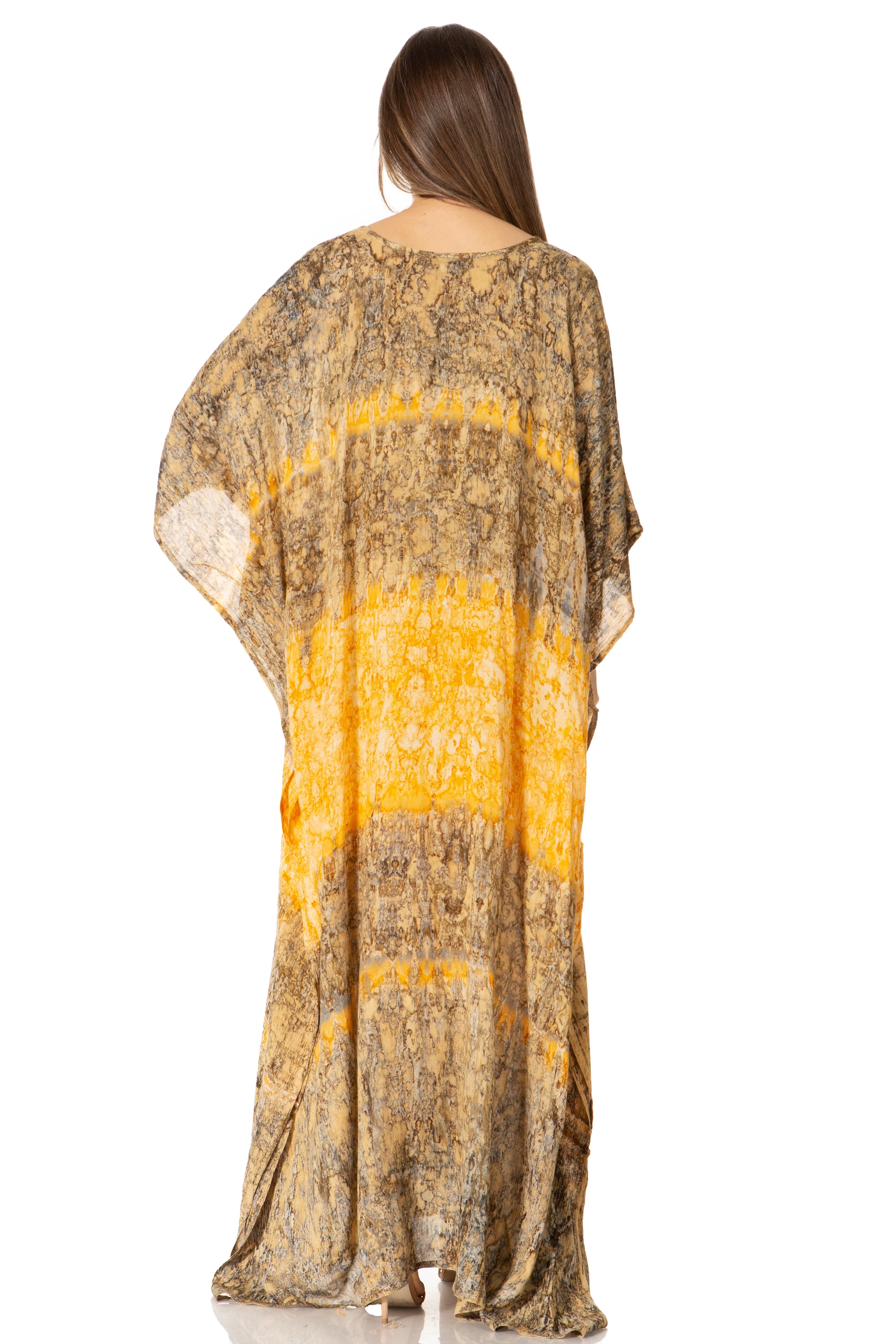 Woman wearing a patterned dress with a yellow and brown design on a white background