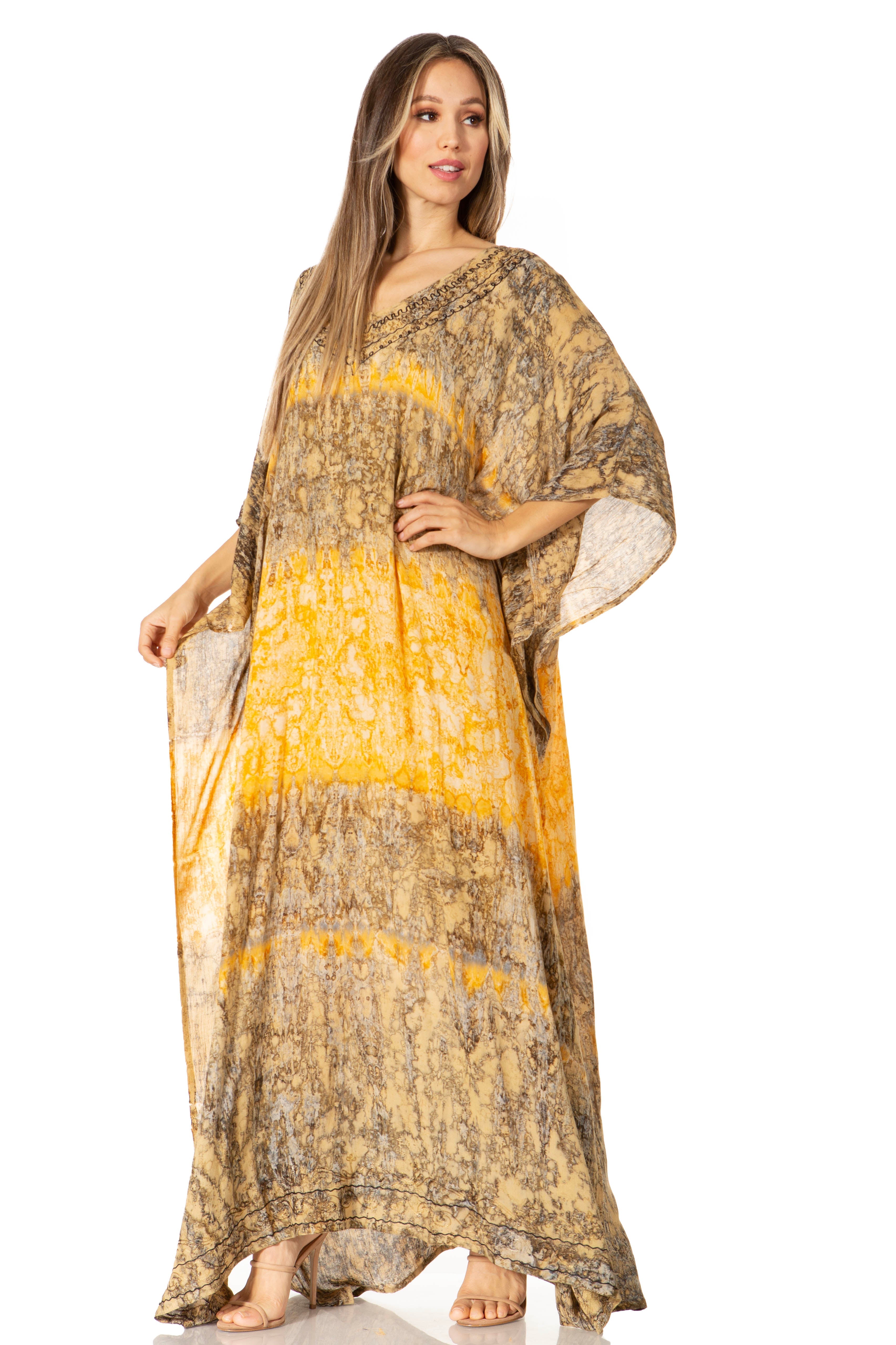 Woman wearing a long, patterned dress with a yellow and brown design on a white background