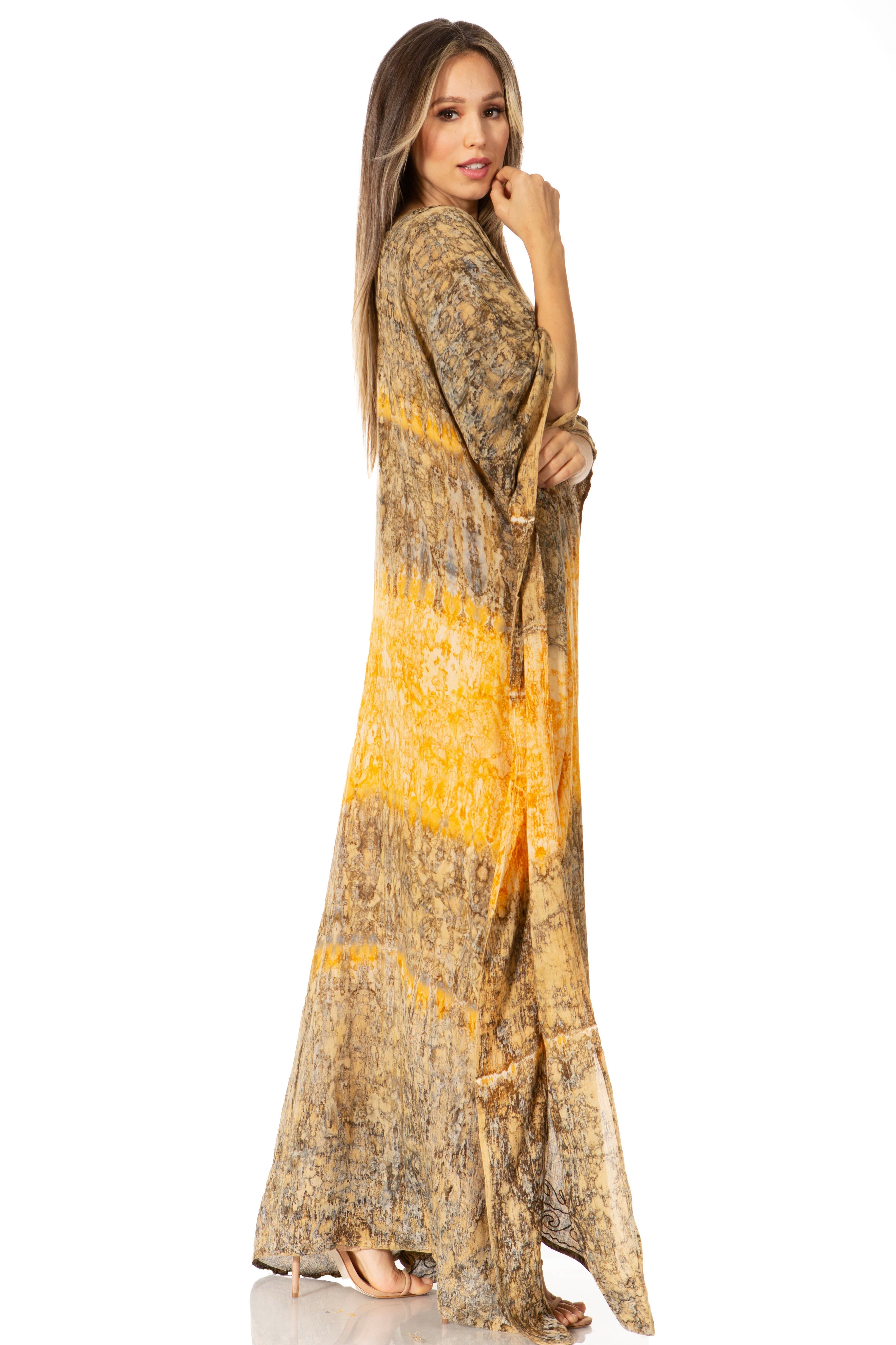 Woman wearing a long, patterned dress with a yellow accent on a white background