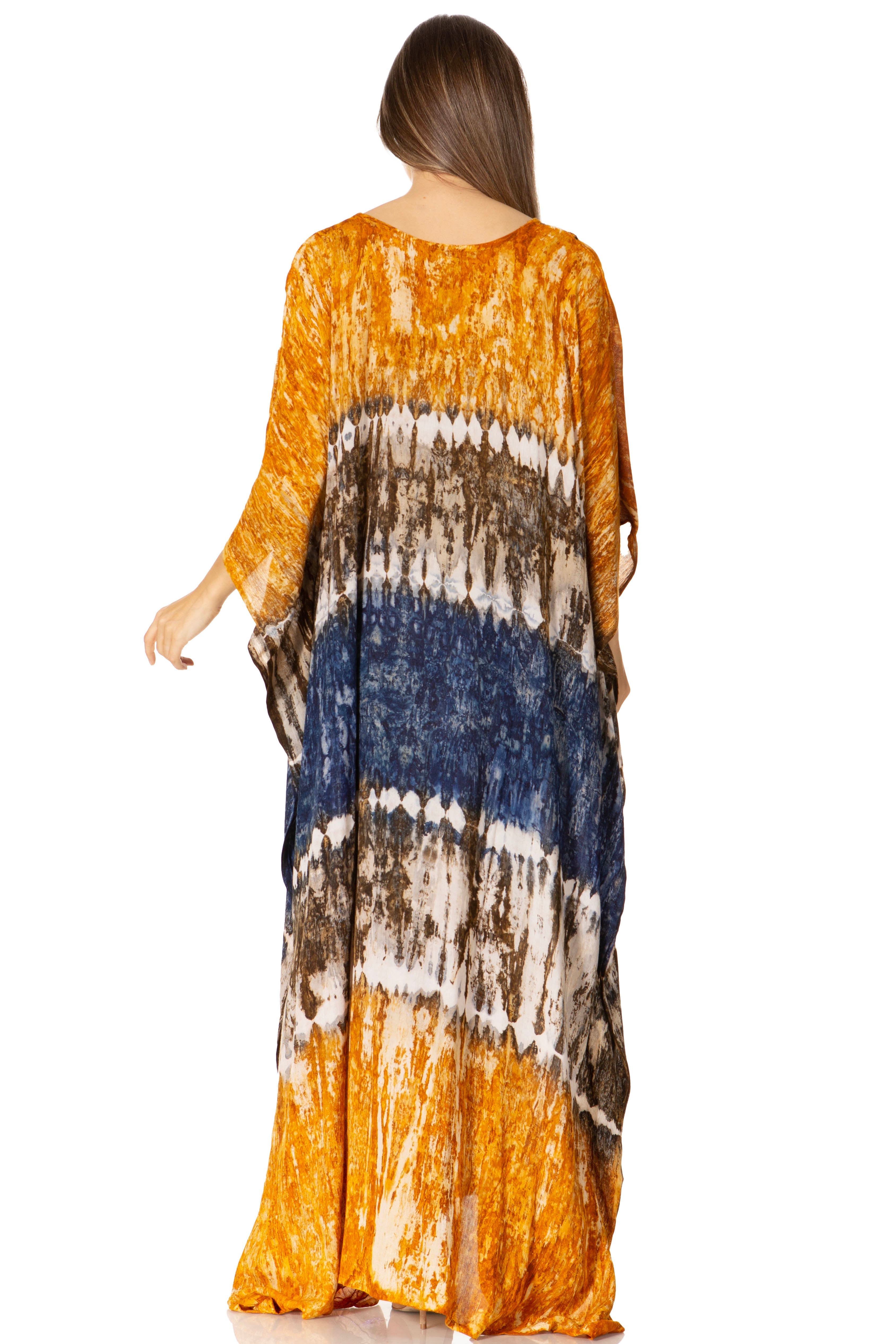 Woman wearing a long, patterned dress with orange, blue, and brown colors on a white background.