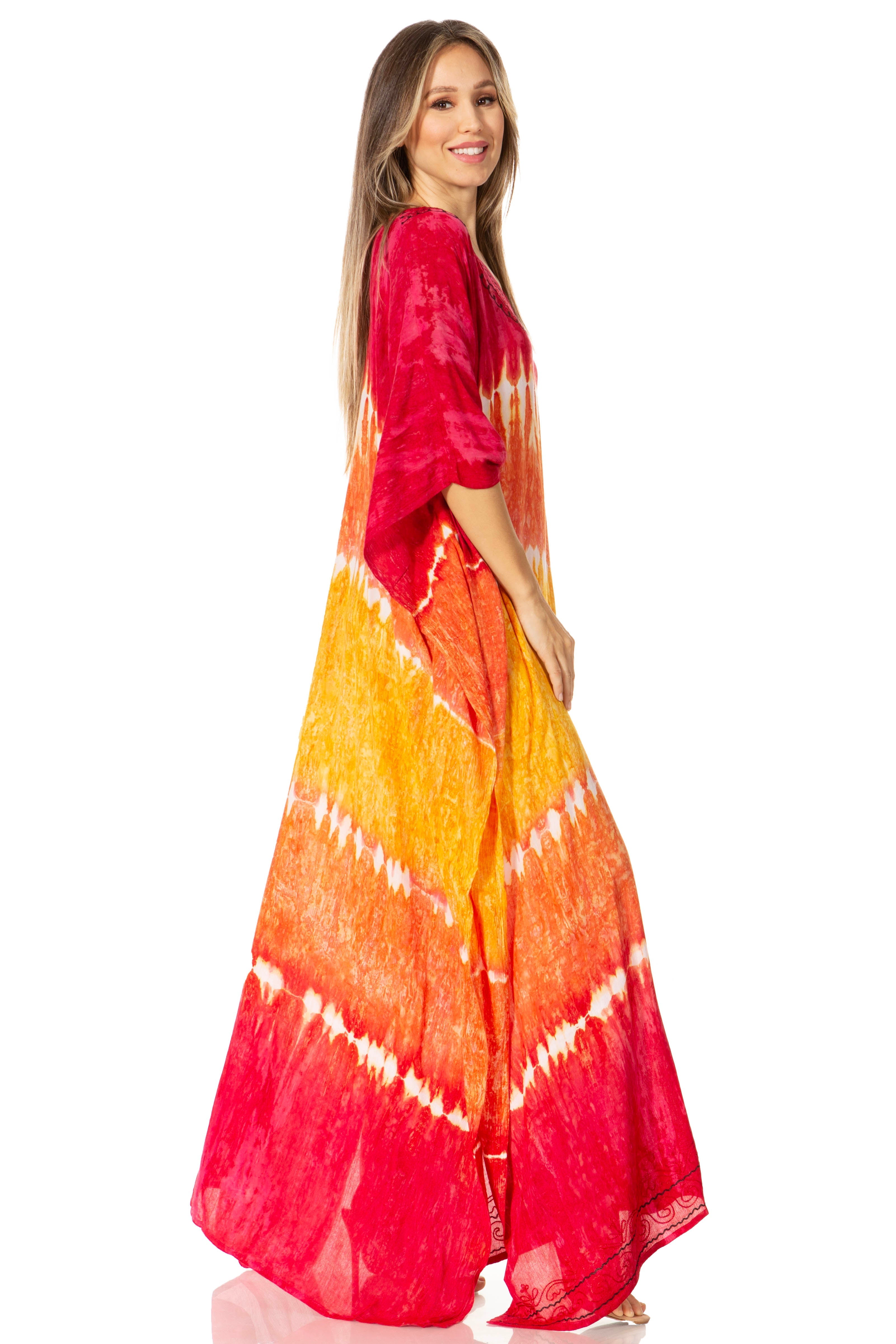 Woman wearing a tie-dye dress with red, orange, and yellow patterns on a white background