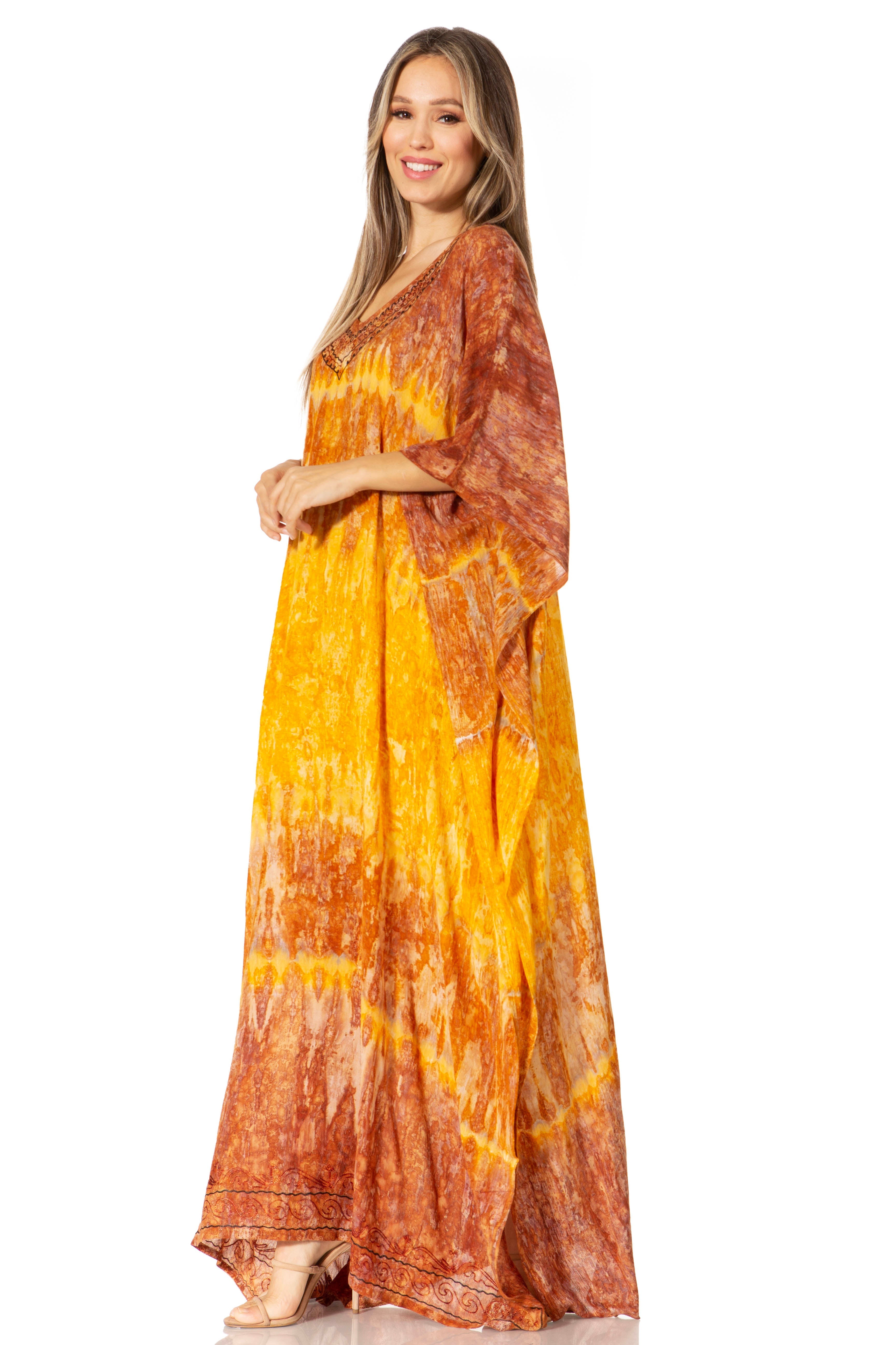 Woman wearing a tie-dye dress with orange and yellow pattern on a white background