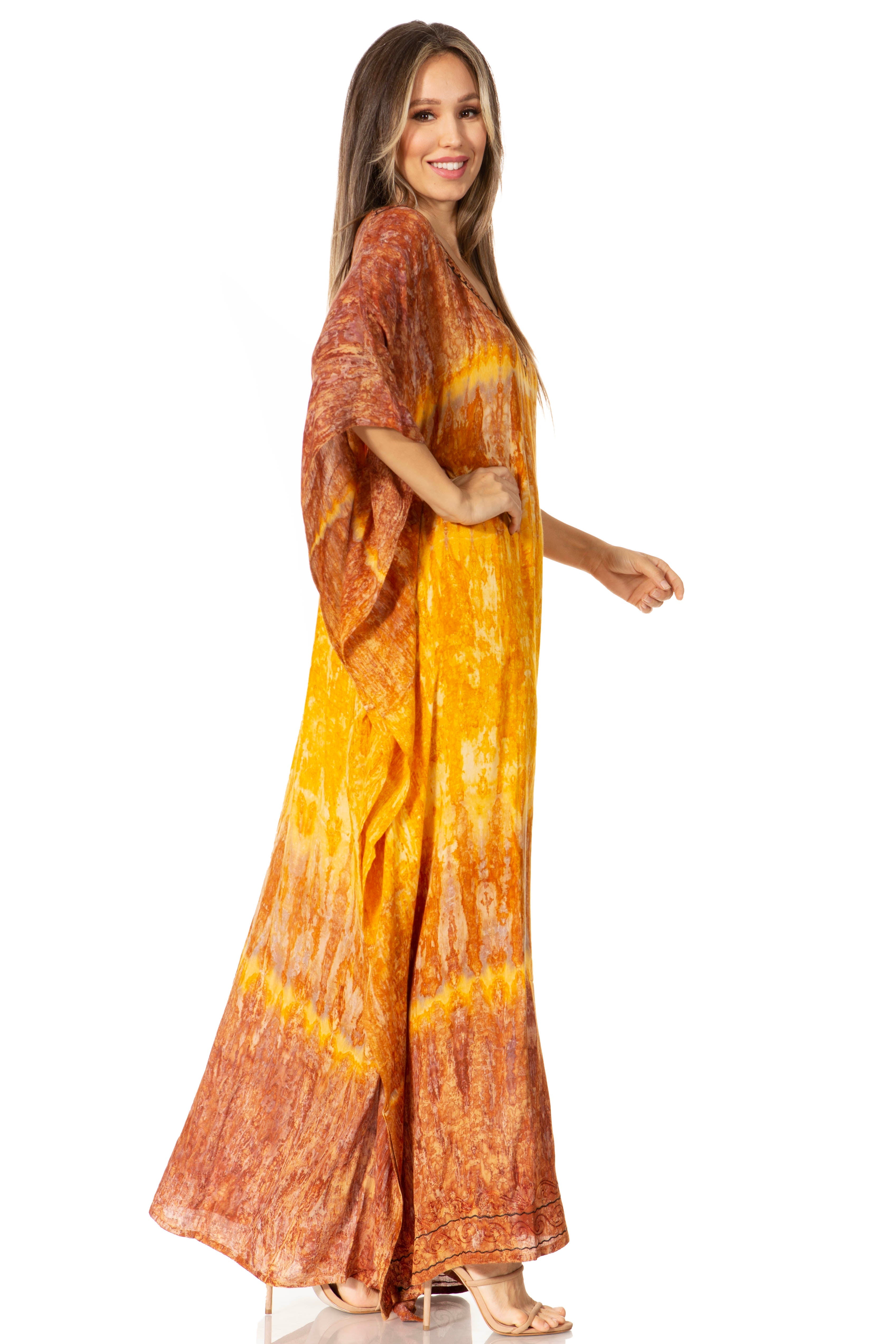 Woman wearing a tie-dye dress with orange and yellow pattern on a white background