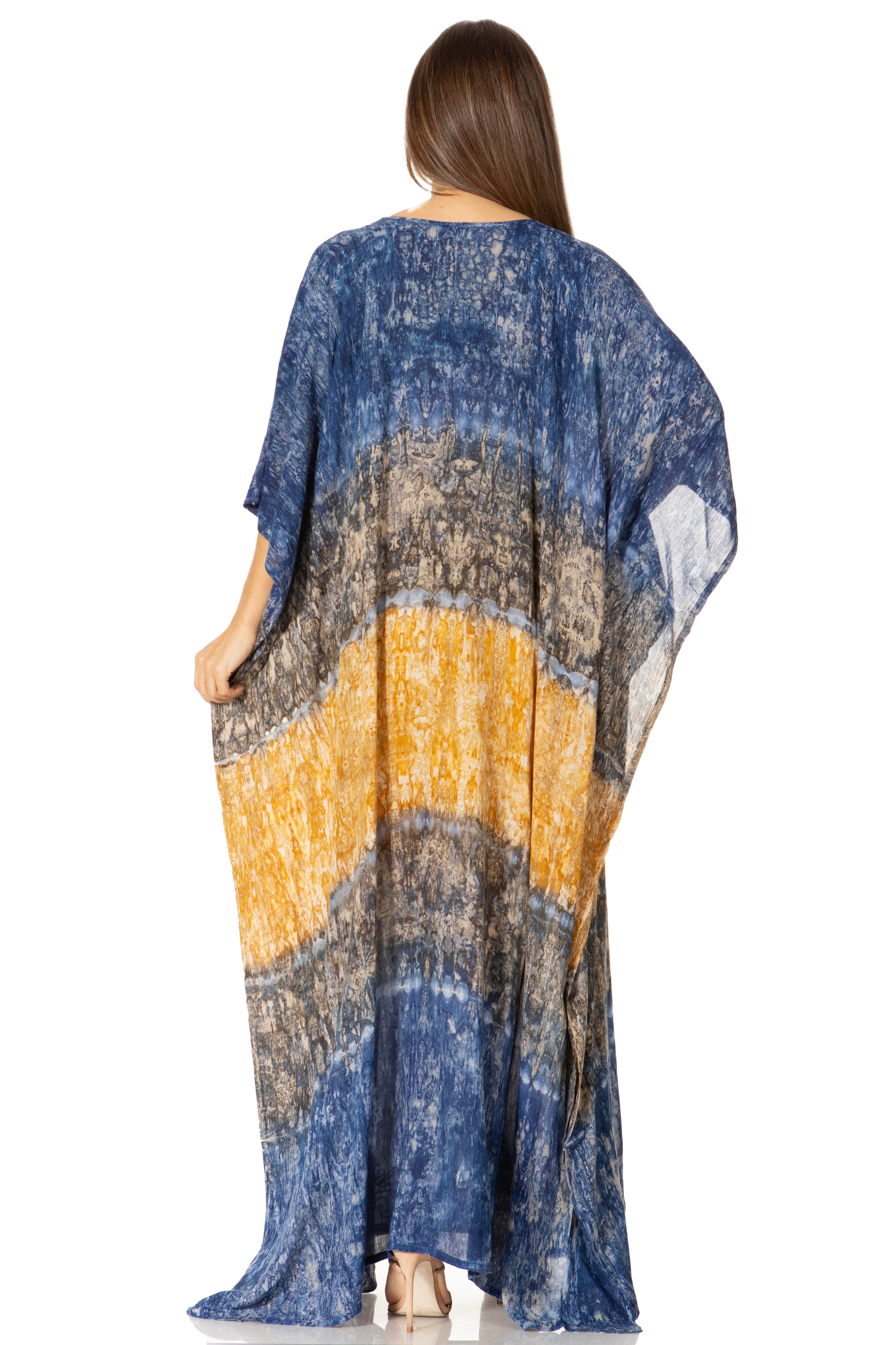 Woman wearing a long, patterned kimono-style garment with a gradient of blue, yellow, and gray.