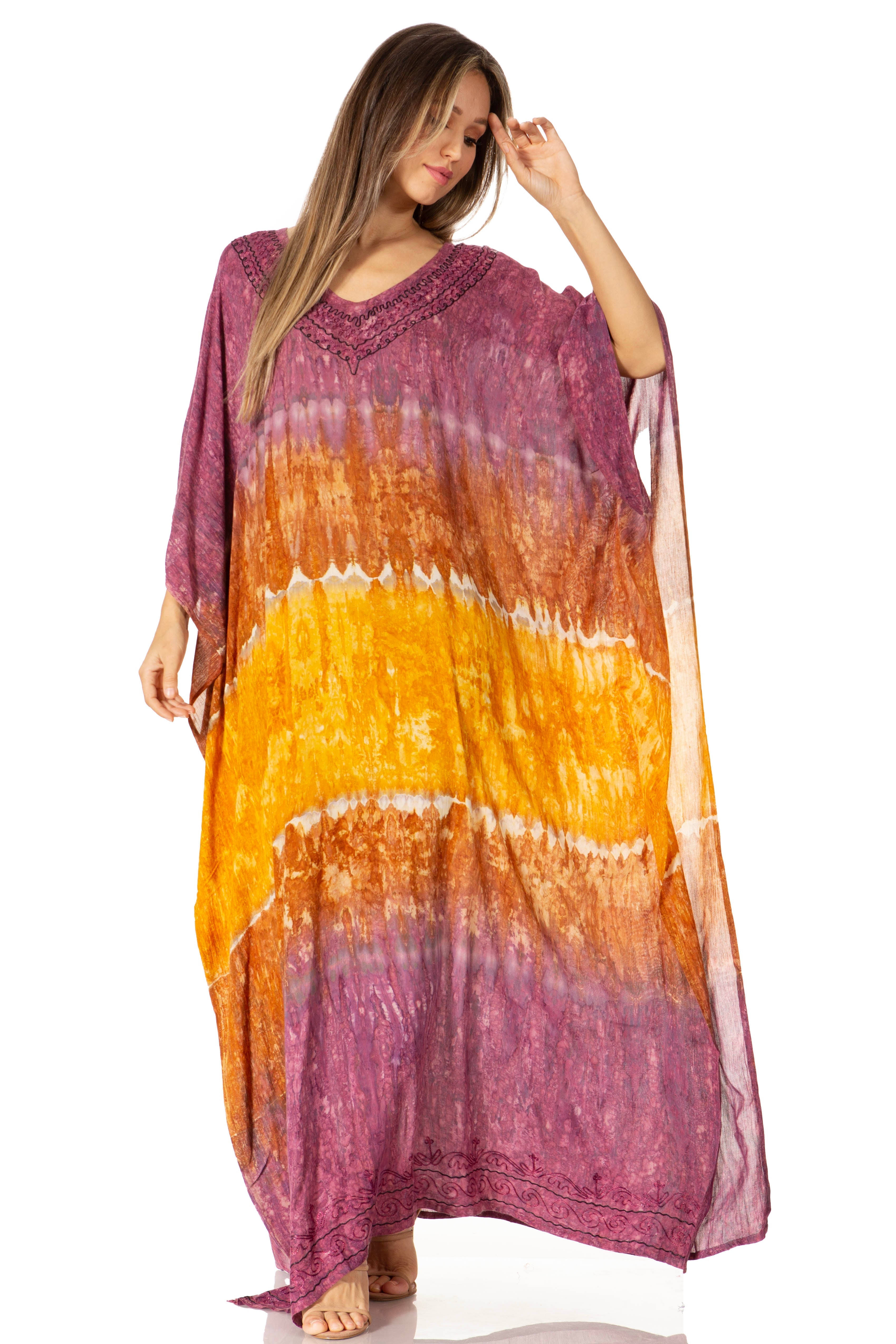 Woman wearing a tie-dye dress with purple, orange, and yellow gradient on a white background