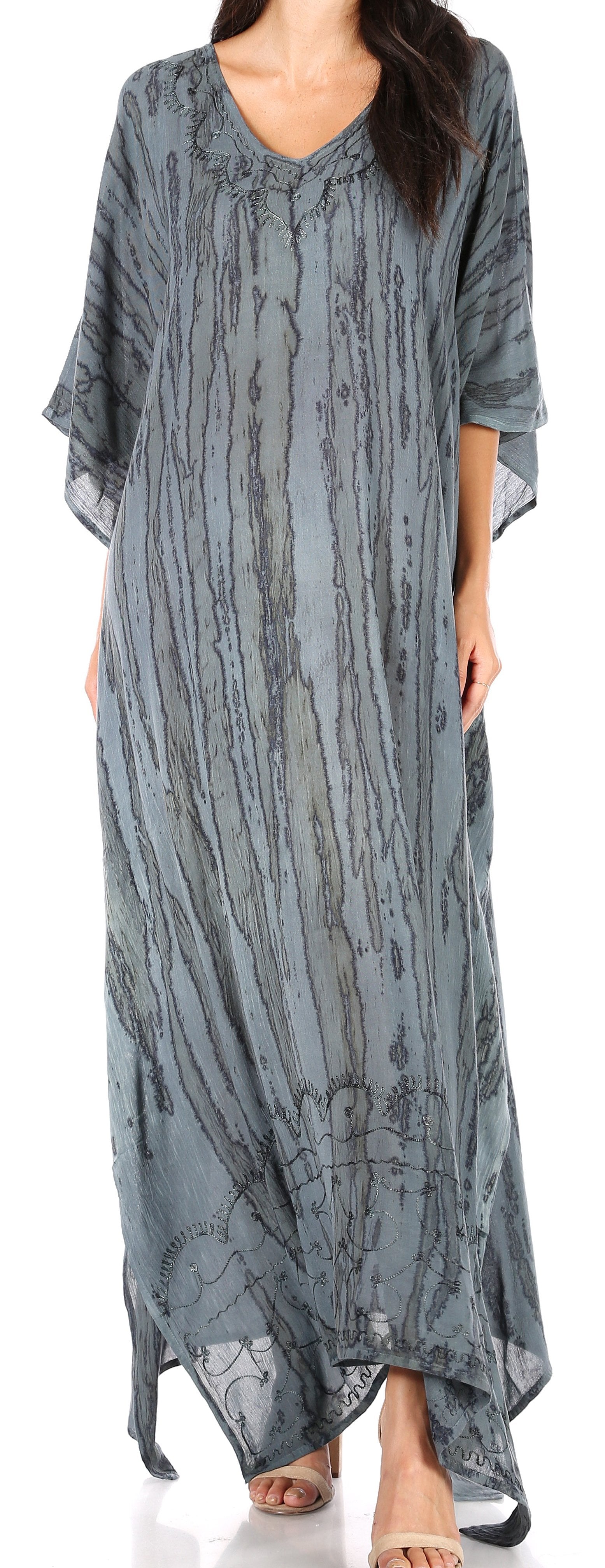 Long, patterned gray dress worn by a model on a white background