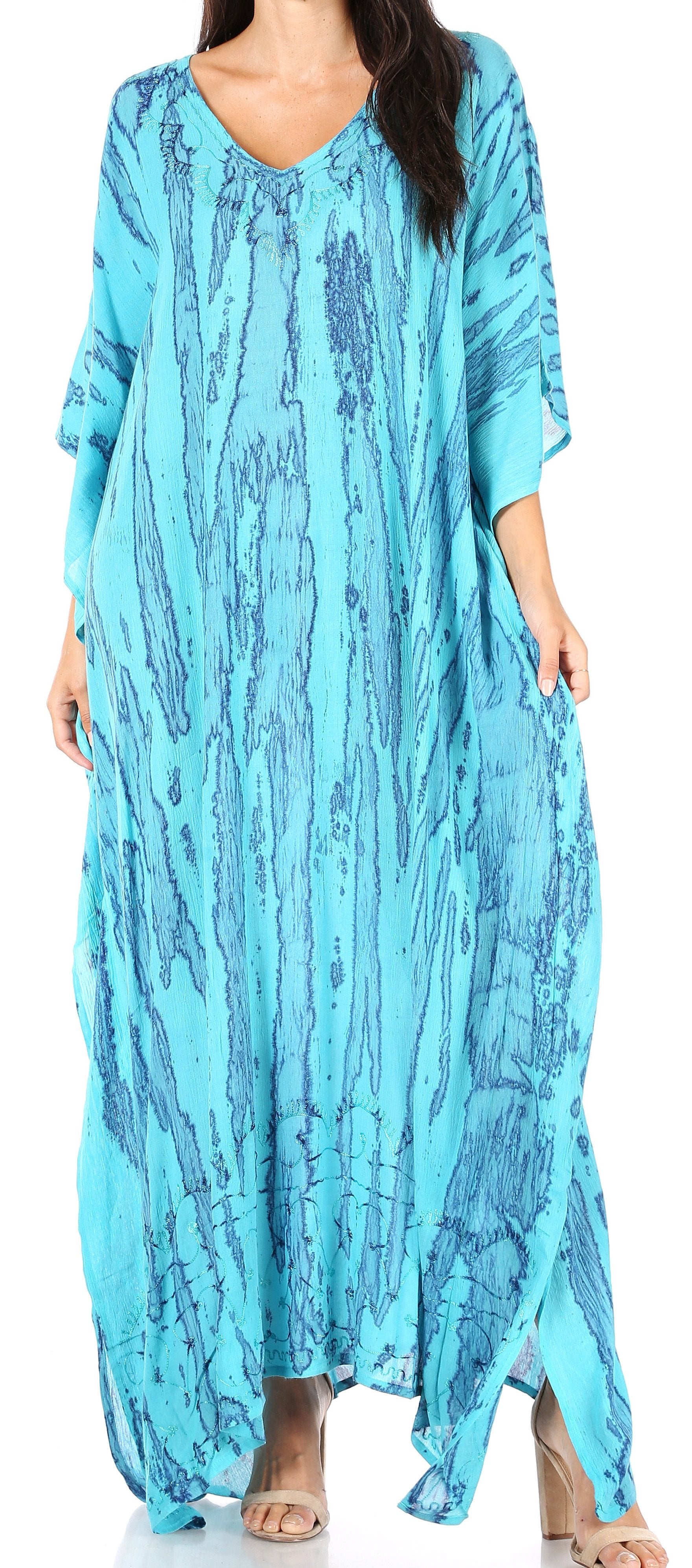 Woman wearing a long, light blue tie-dye dress with a loose fit.