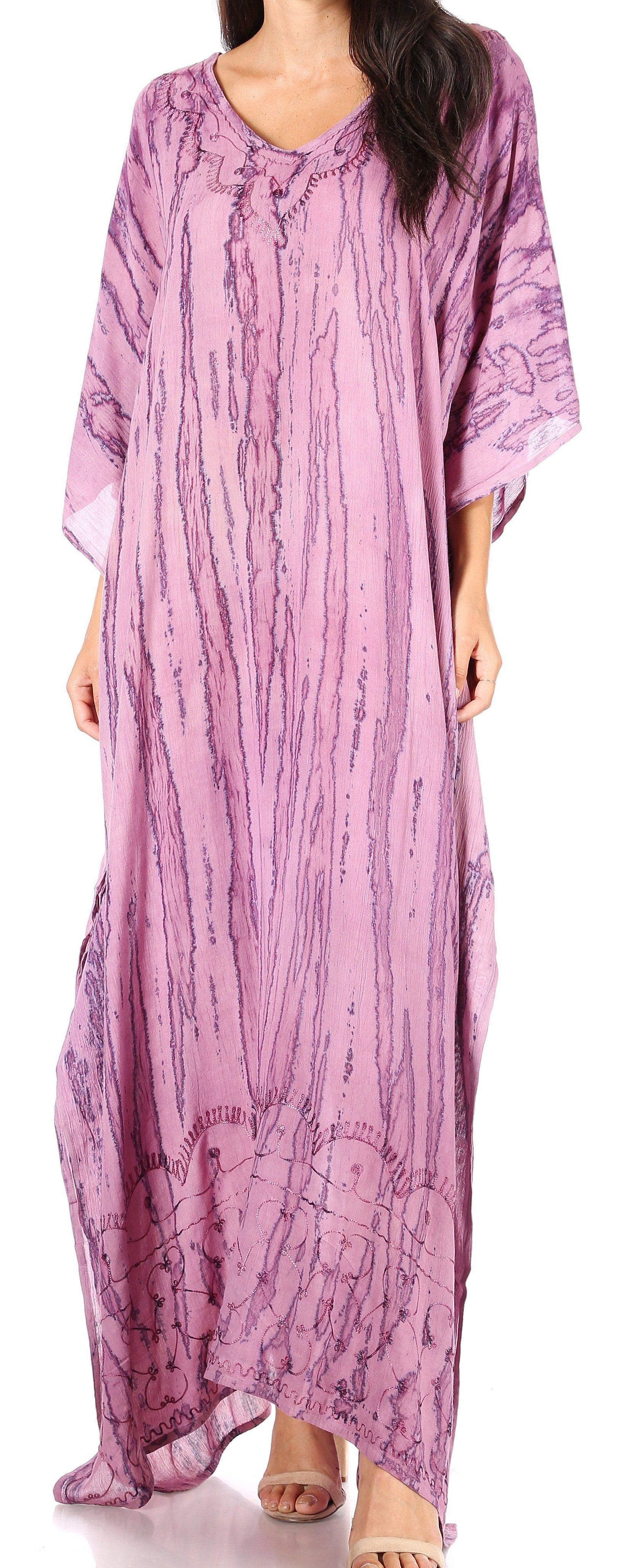 Woman wearing a long, light purple dress with a subtle pattern on a white background