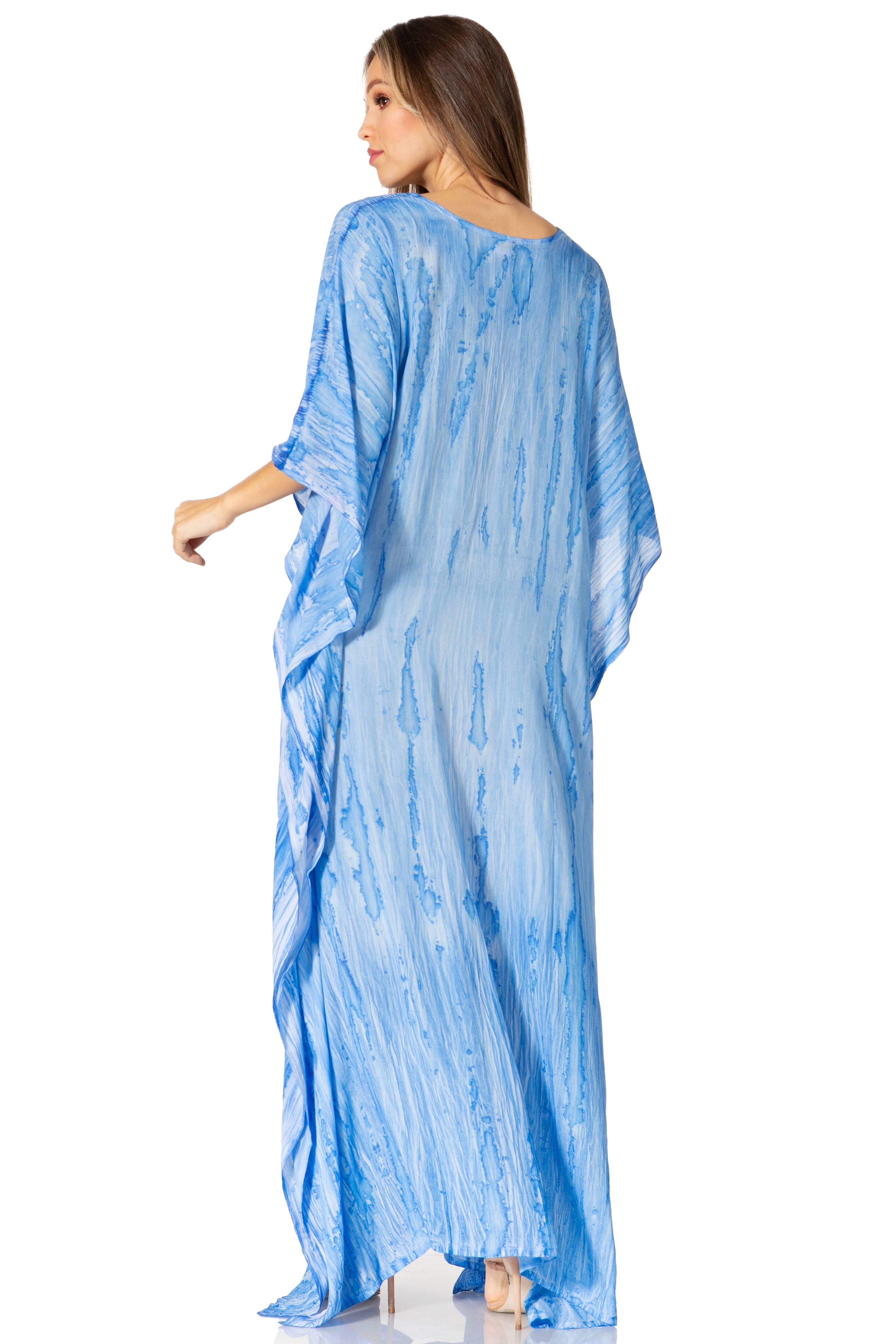 Woman wearing a blue patterned dress on a white background