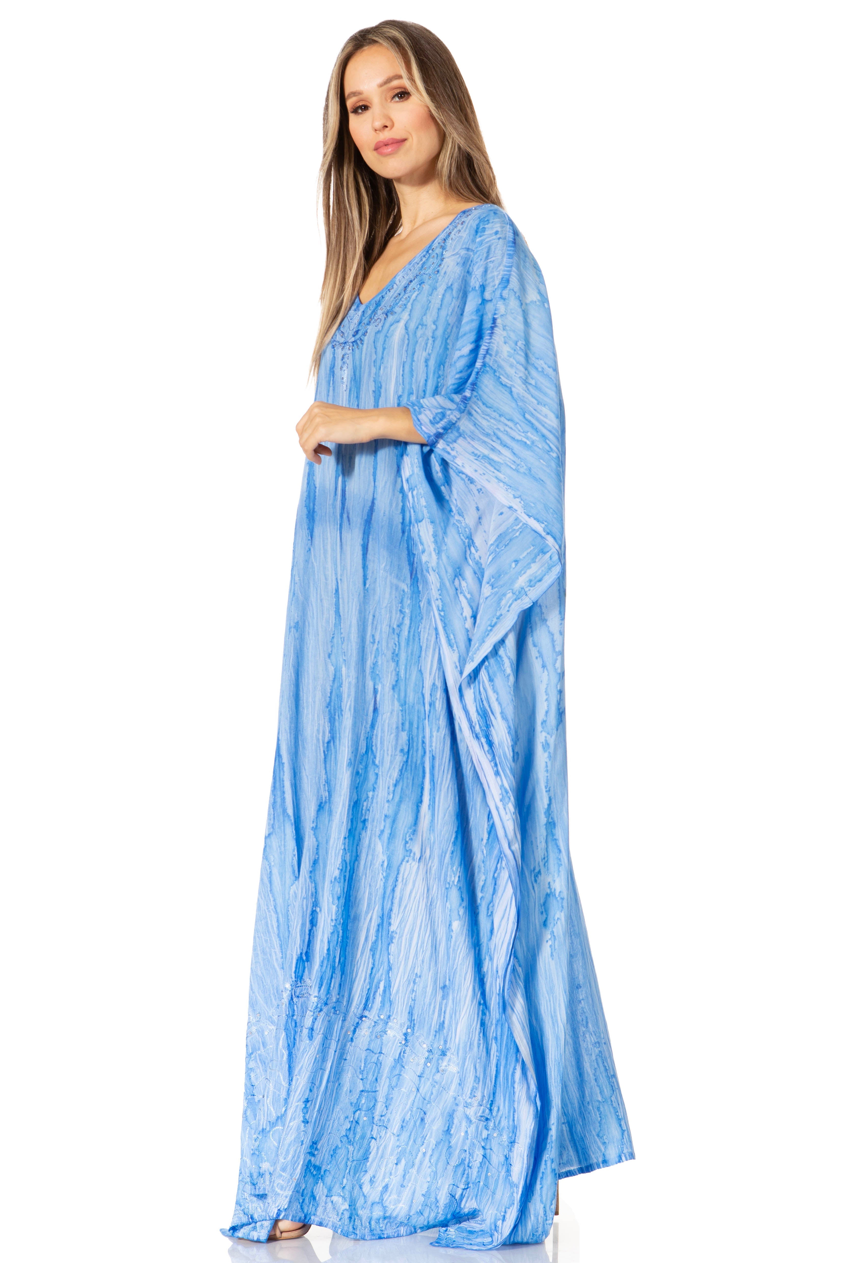 Woman wearing a blue patterned dress on a white background