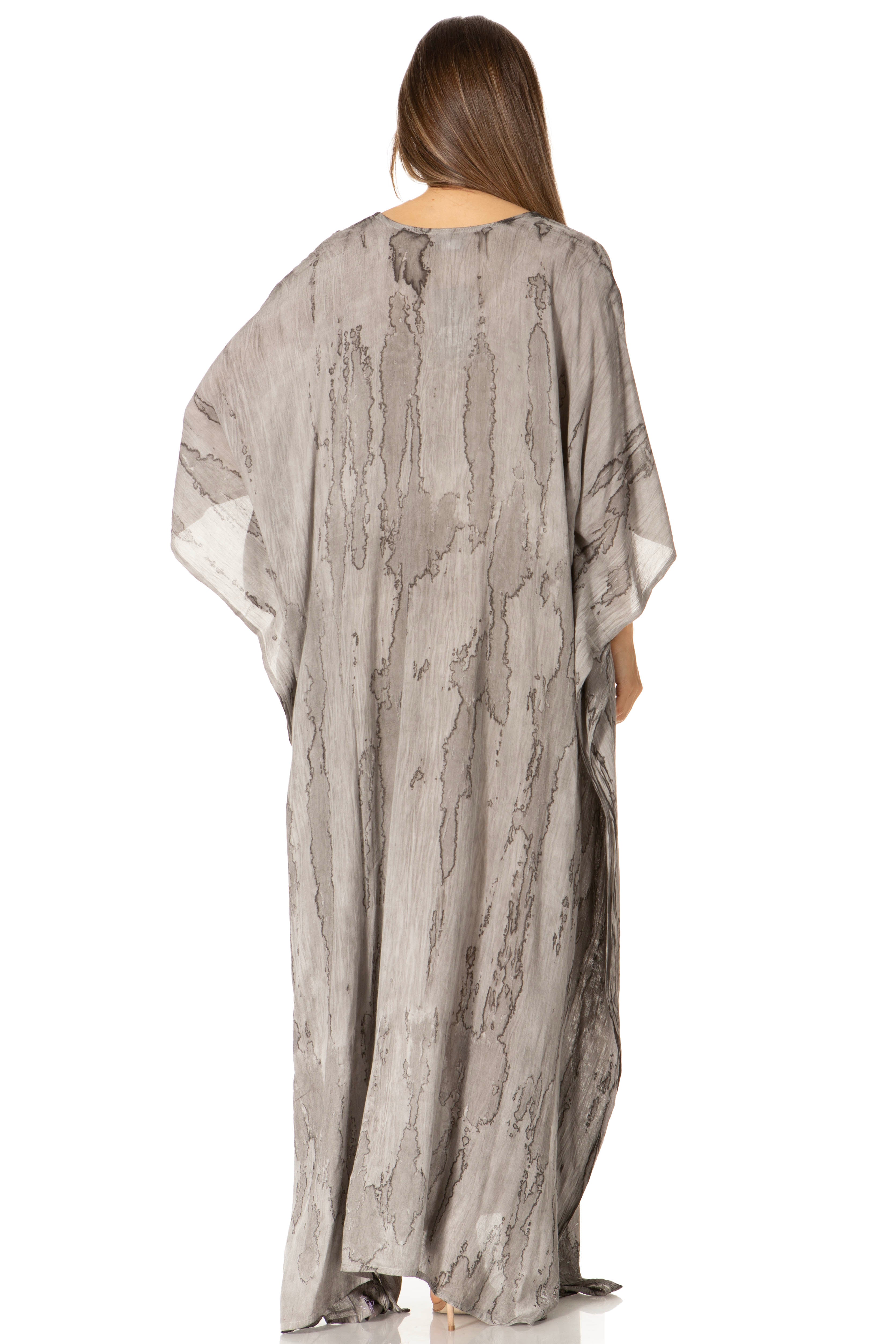 Woman wearing a long, patterned dress on a white background