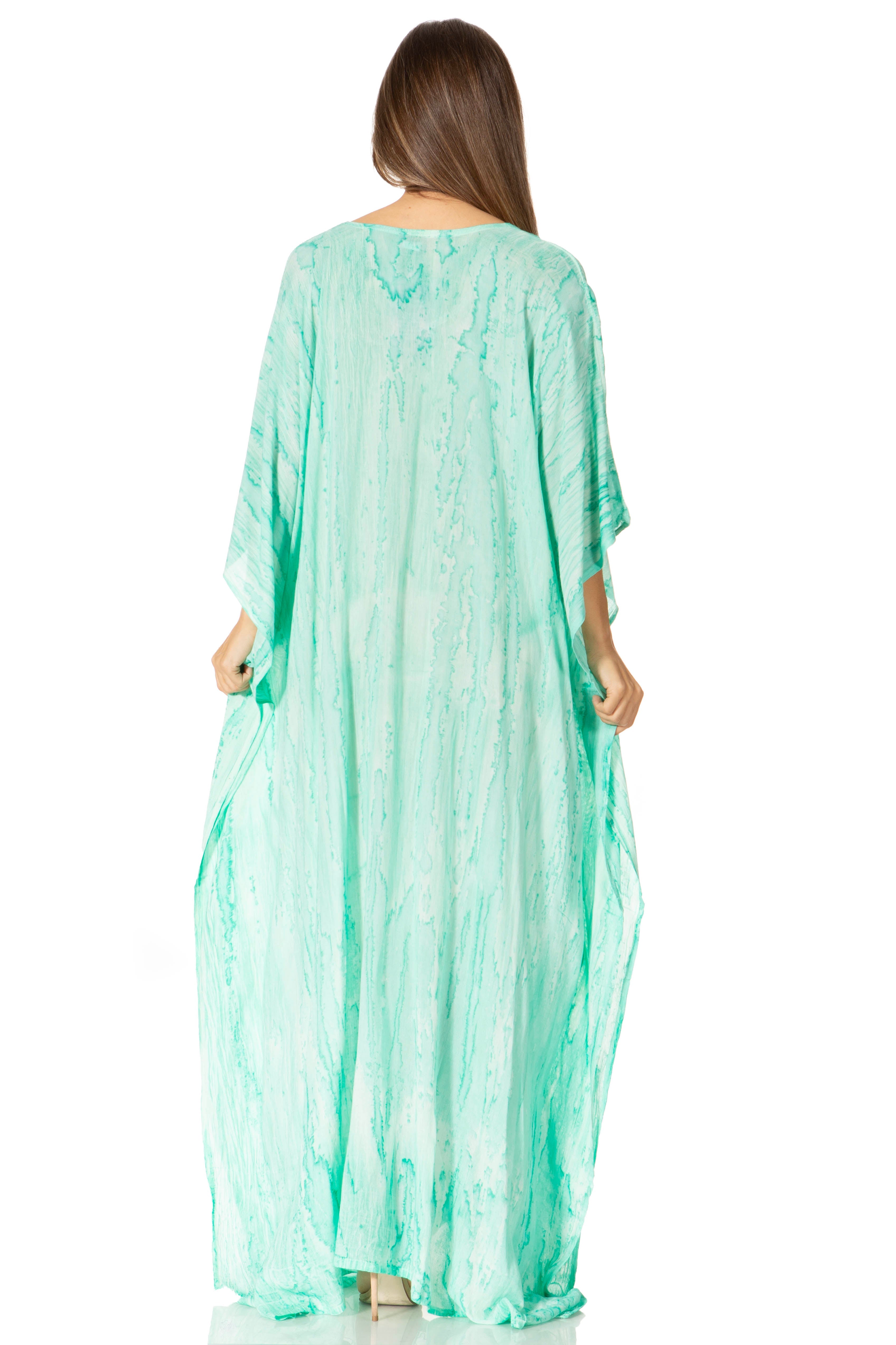 Woman wearing a light green caftan on a white background