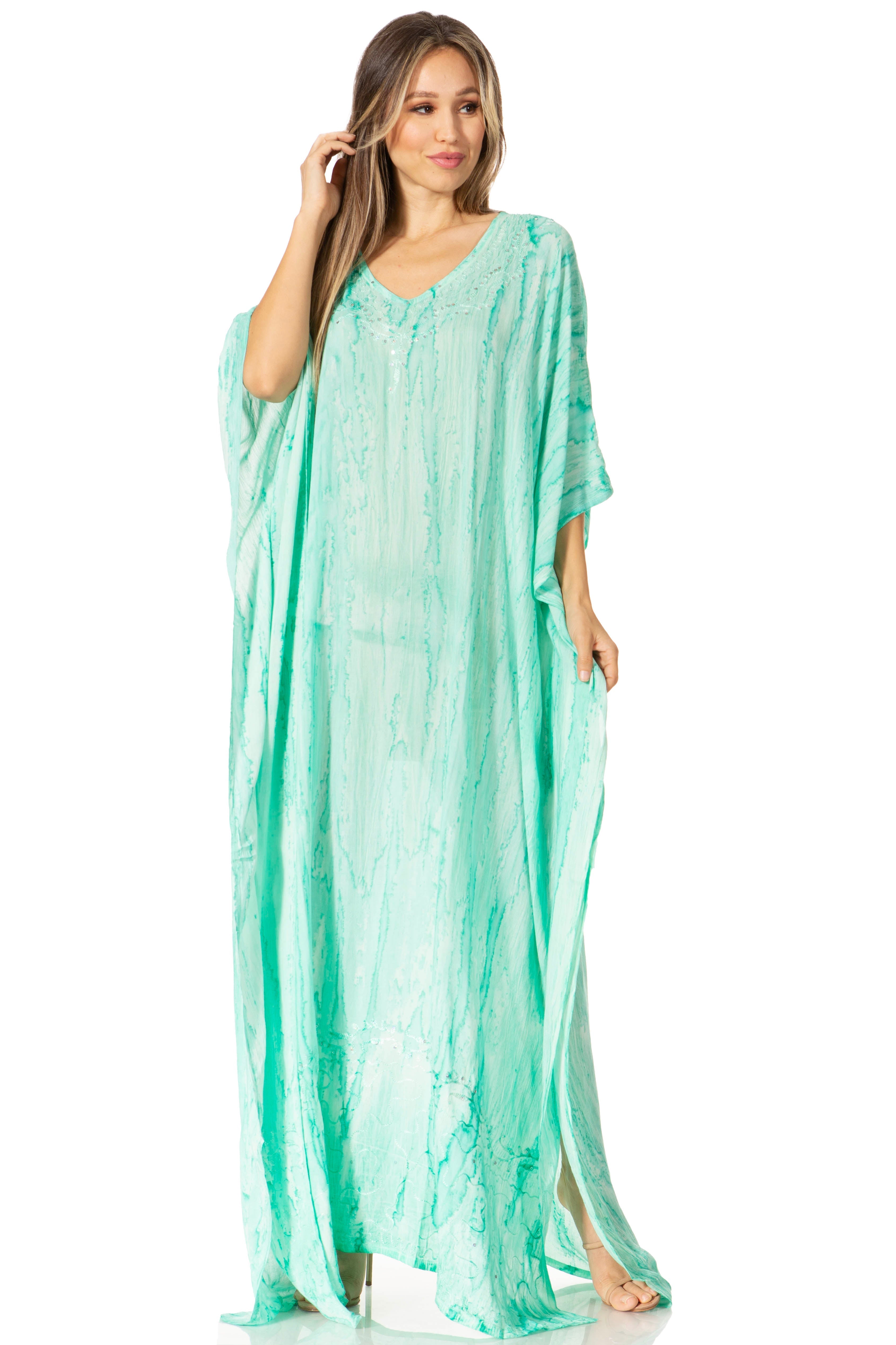 Woman wearing a light green caftan on a white background