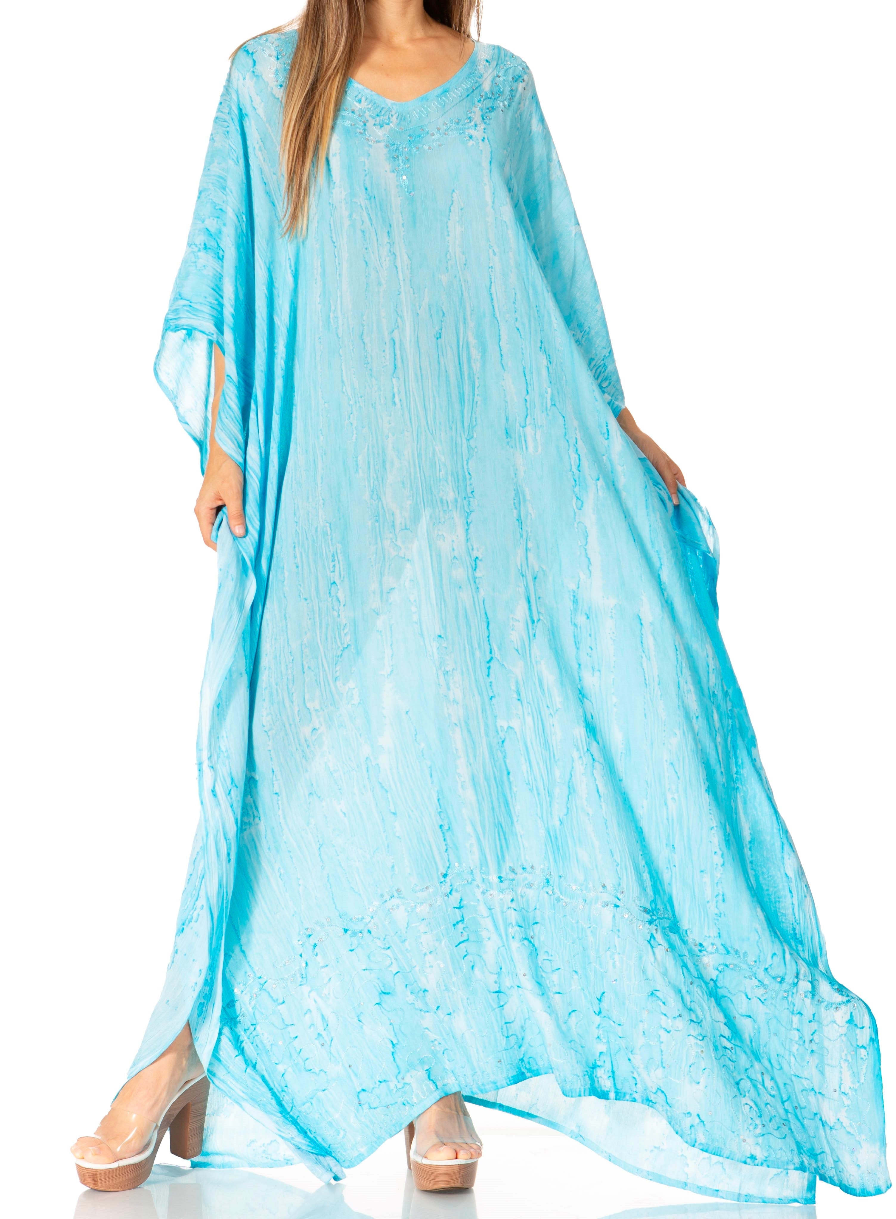 Woman wearing a light blue dress with a flowing design on a white background