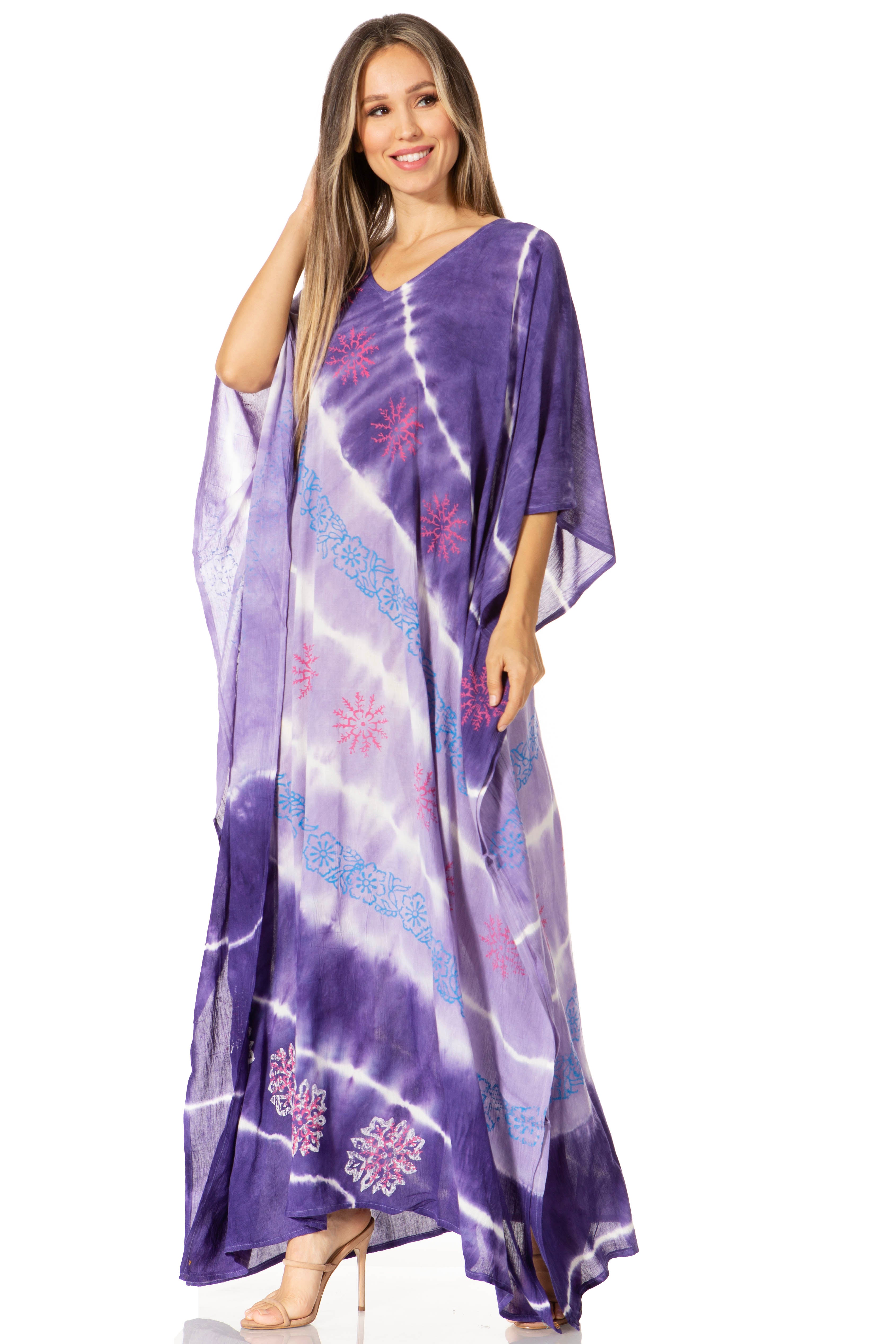 Woman wearing a purple tie-dye dress with floral patterns on a white background