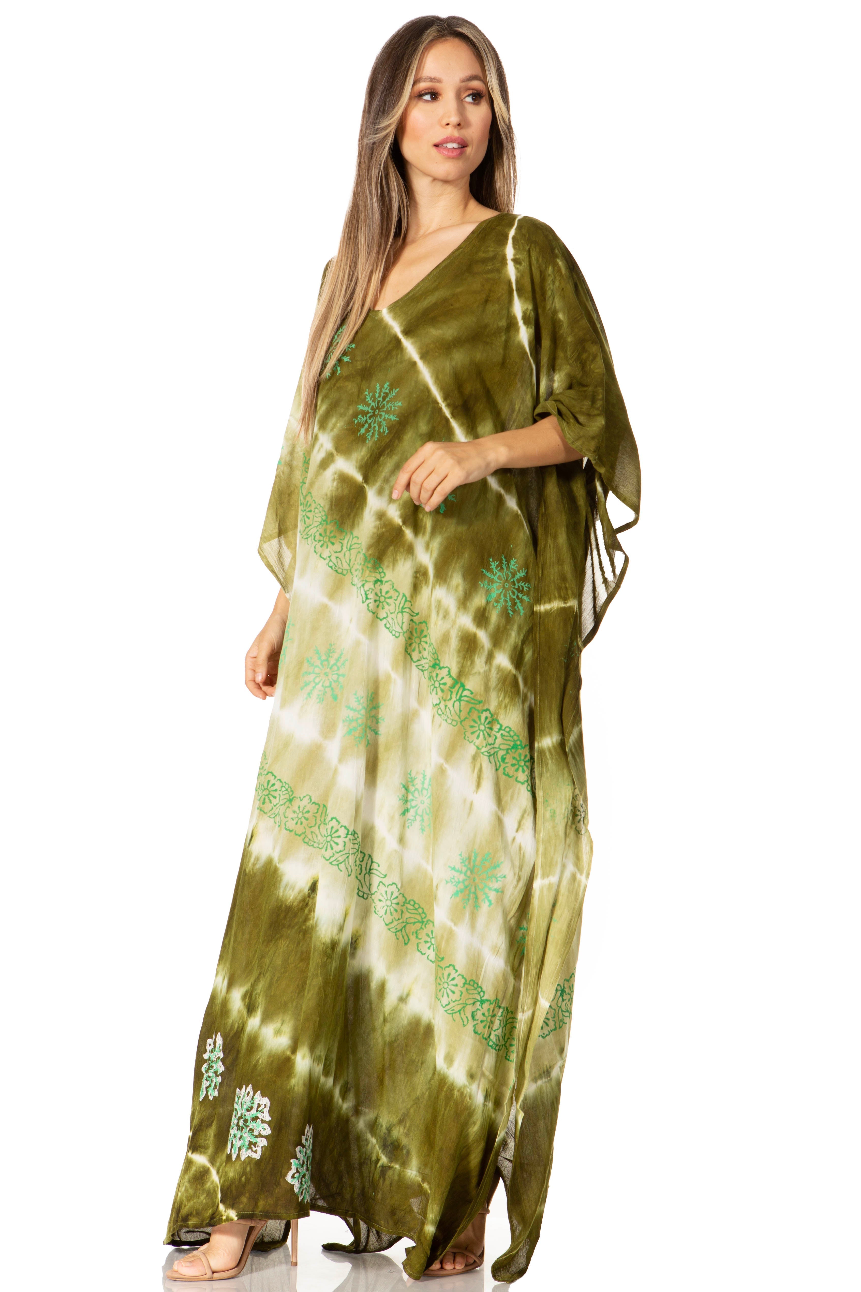 Woman wearing a green tie-dye dress with floral patterns on a white background