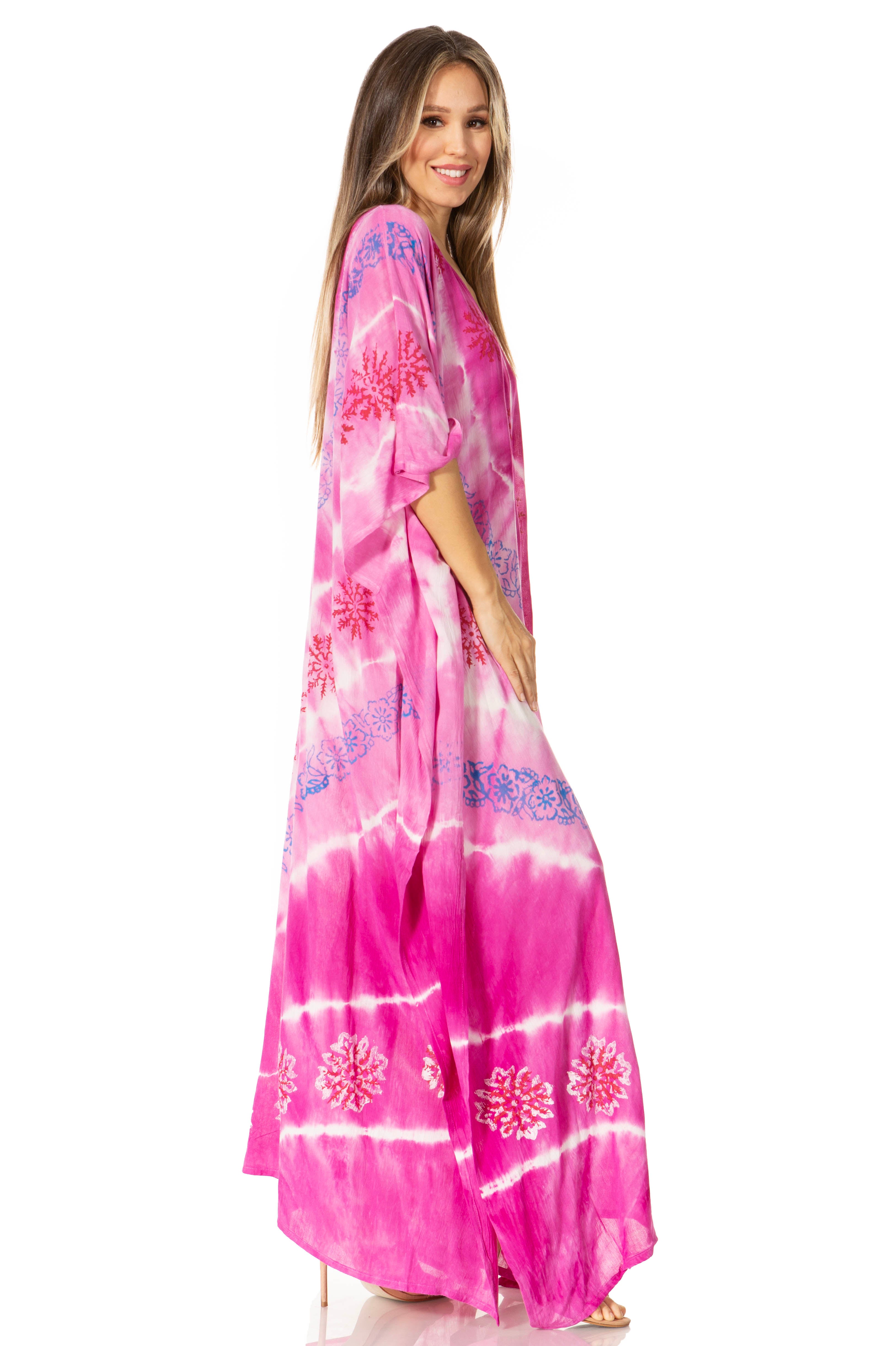 Woman wearing a pink tie-dye dress with floral patterns on a white background