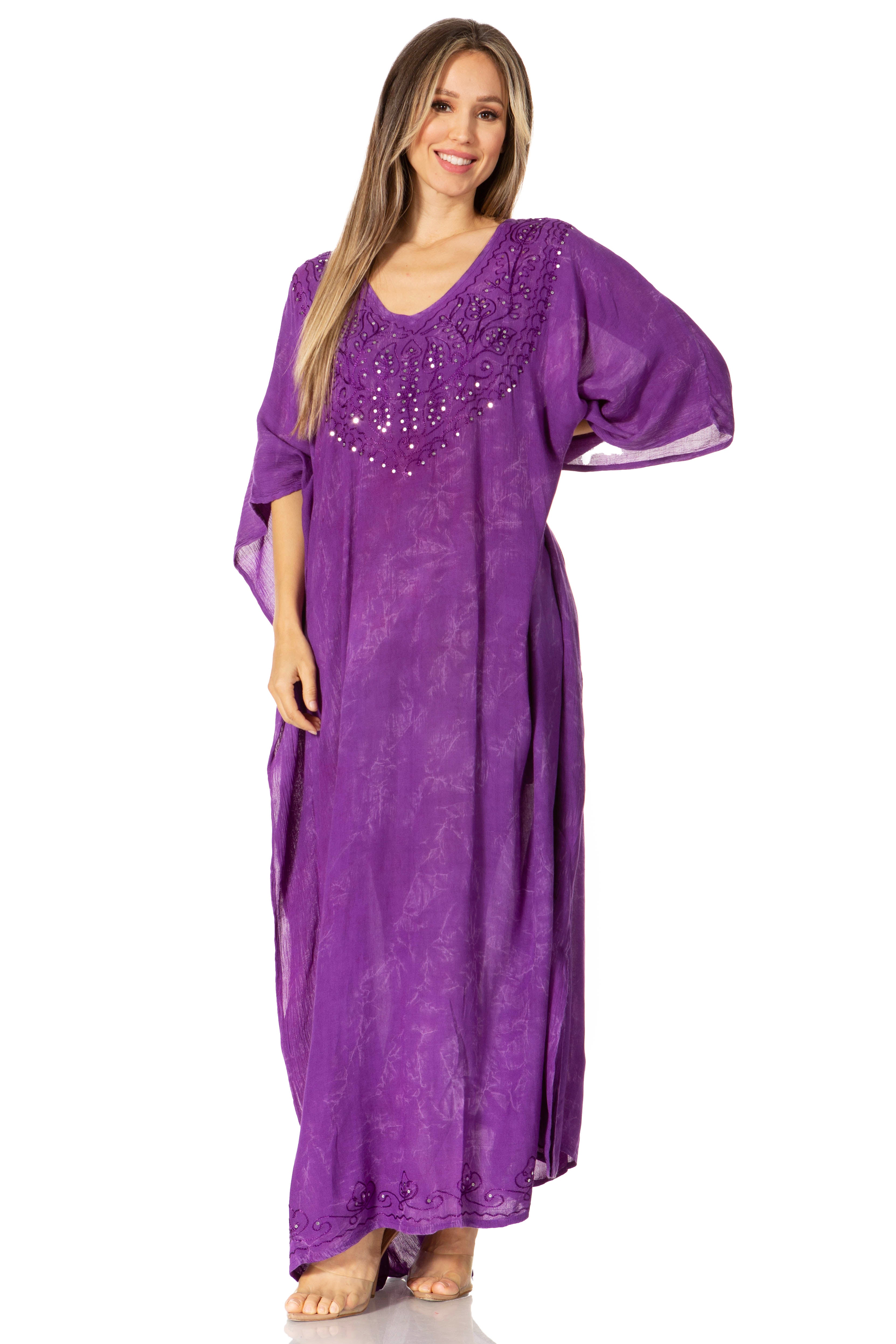 Woman wearing a purple dress with beaded embellishments on a white background