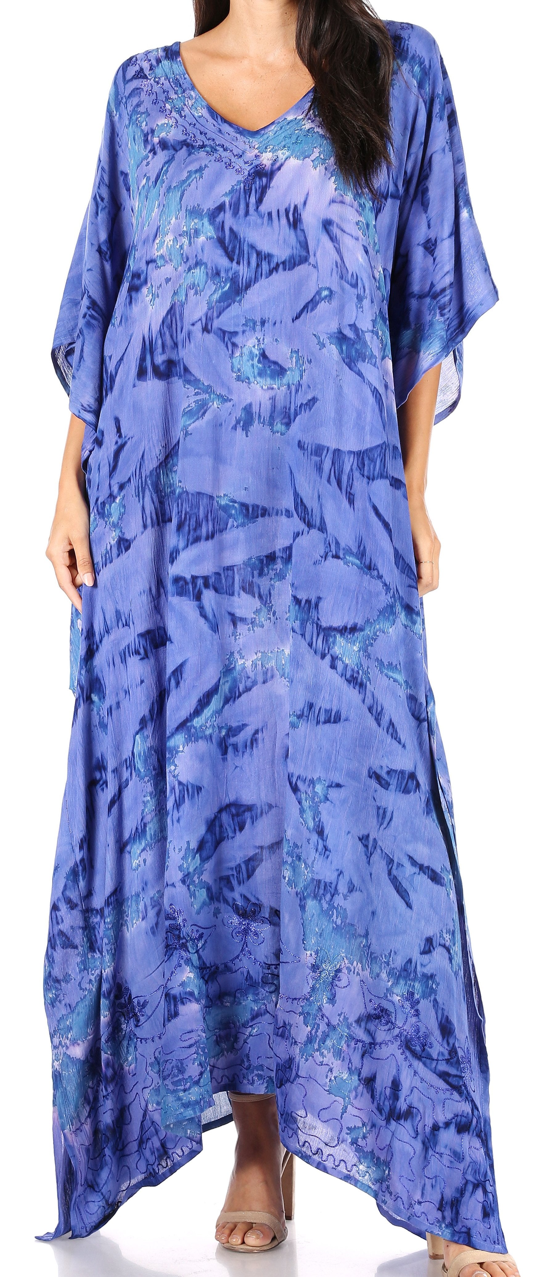 Woman wearing a blue patterned dress with a white background