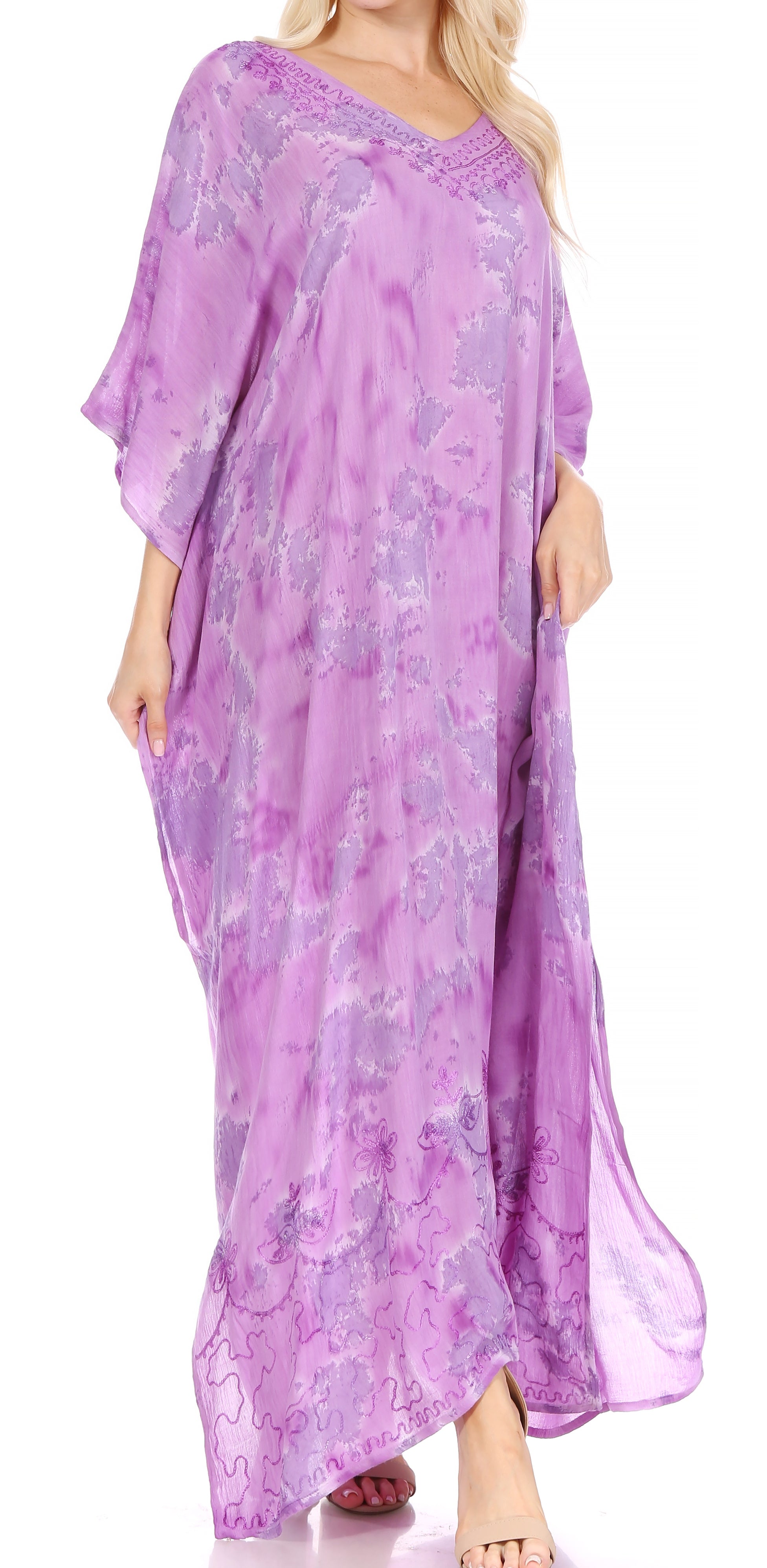 Woman wearing a purple floral dress on a white background